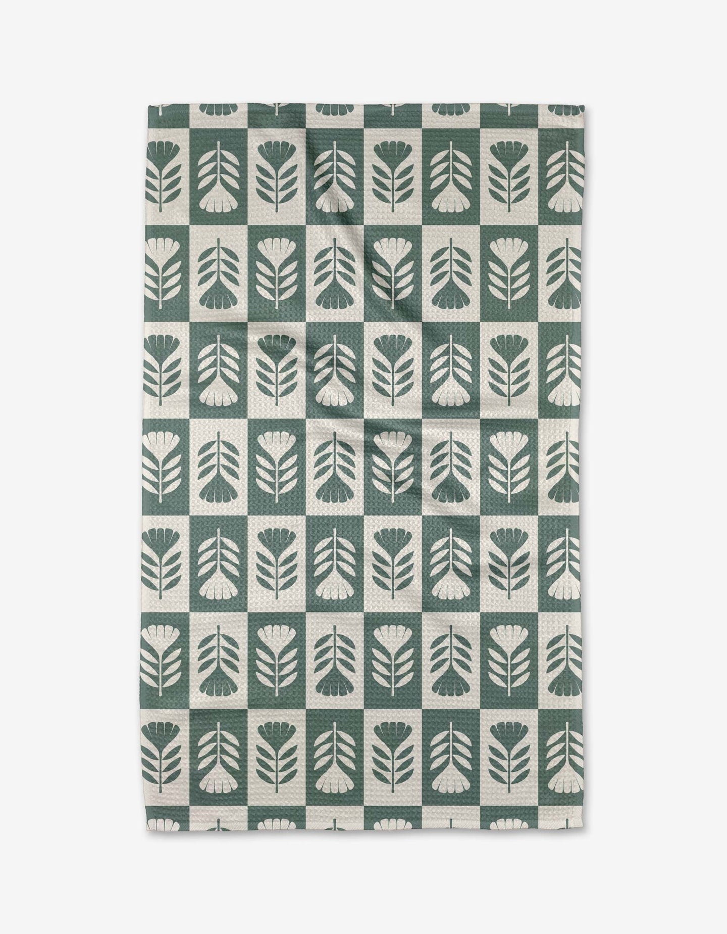 The Green Flower Patch tea towel by Charlie Rowan Designs features a grid of stylized green and white flowers and leaves. Crafted from Geoweave fabric, it blends modern style with superior absorbency.
