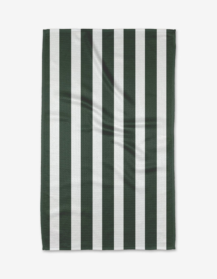 The Greens Tea Towel by BetterDays features vertical dark green and white stripes, is laid flat to show its textured Geoweave fabric with gentle creases, highlighting its durable construction.