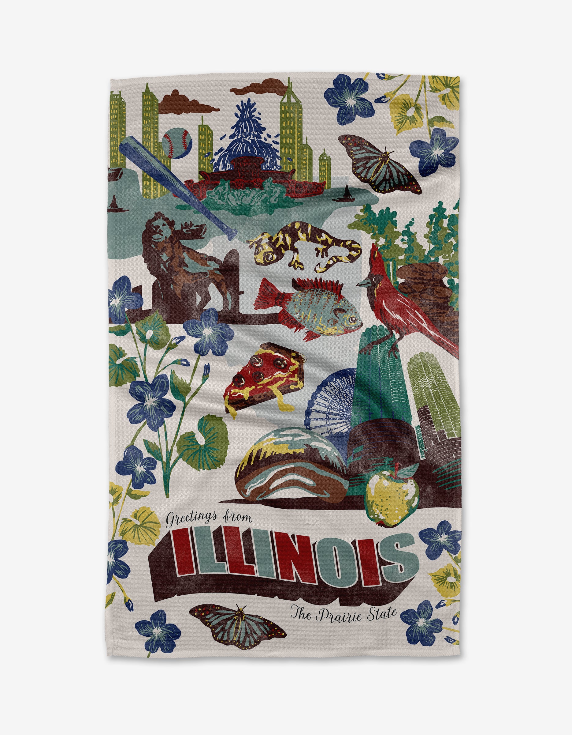 The Geometry "Greetings From Illinois" tea towel features a colorful illustration of Illinois symbols—skyline, lion statue, cardinals, corn, flowers, butterflies—and the phrase “Greetings from ILLINOIS—The Prairie State” on a quick-drying background.