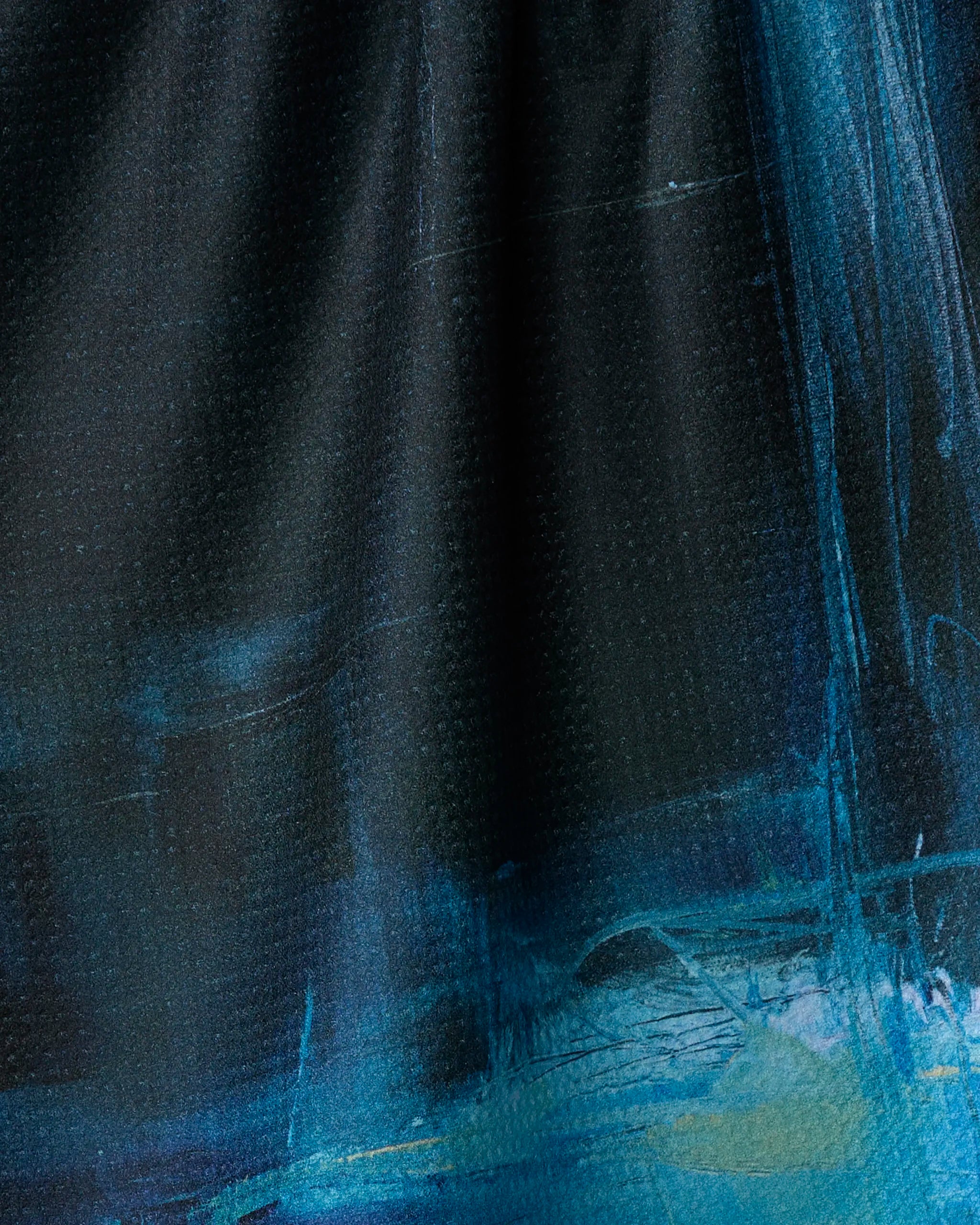 Grotto by Jennifer Janesko is an abstract painting with deep blue and black tones accented by lighter blue and turquoise. Broad, textured brushstrokes evoke depth, inspired by recycled-material kitchen tea towel patterns.