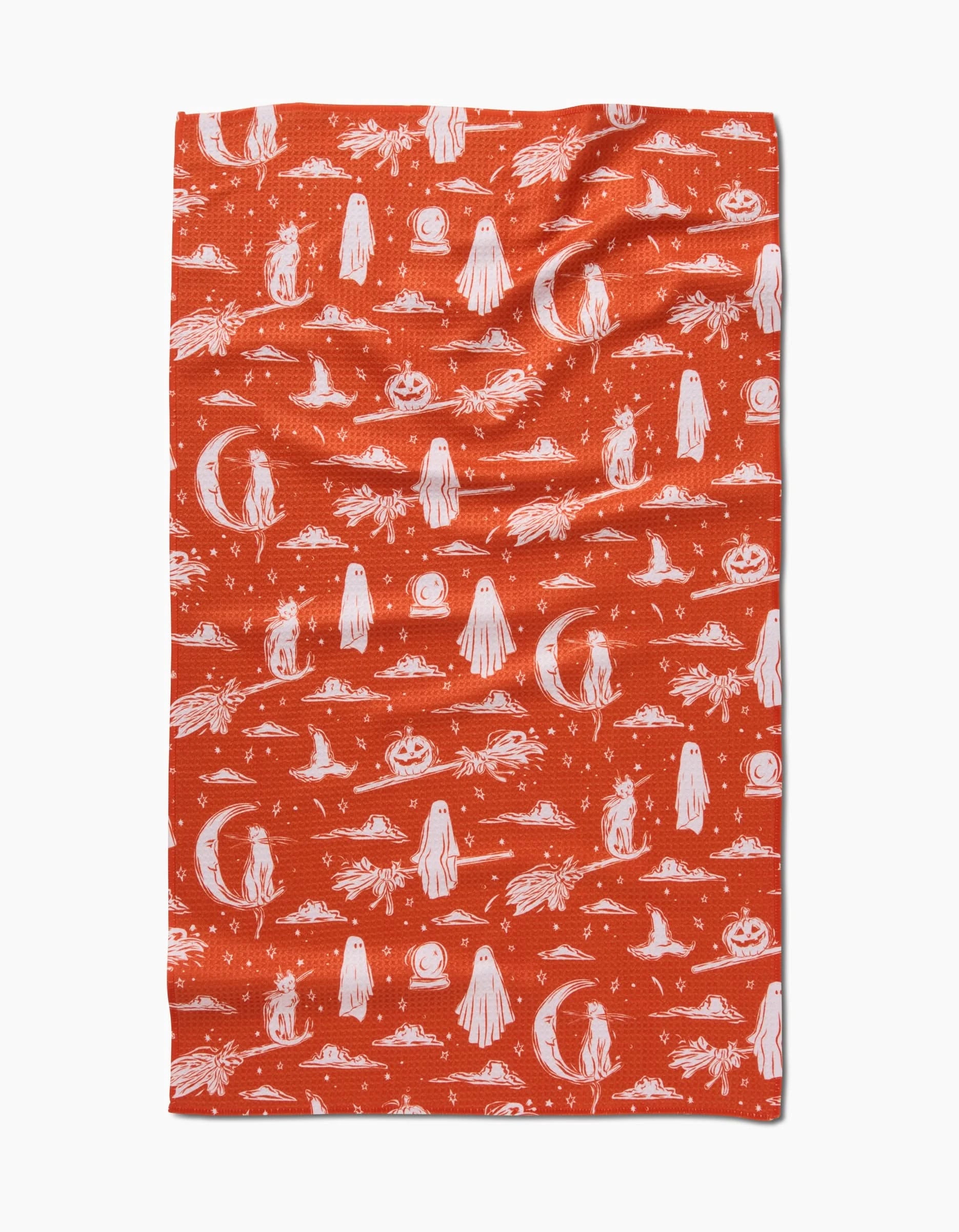 The Halloween Cats And Ghosts cloth by Aubrey Fairchild features a white Halloween pattern of ghosts, pumpkins, black cats, moons, bats, and stars on orange quick-drying Geoweave™ fabric.