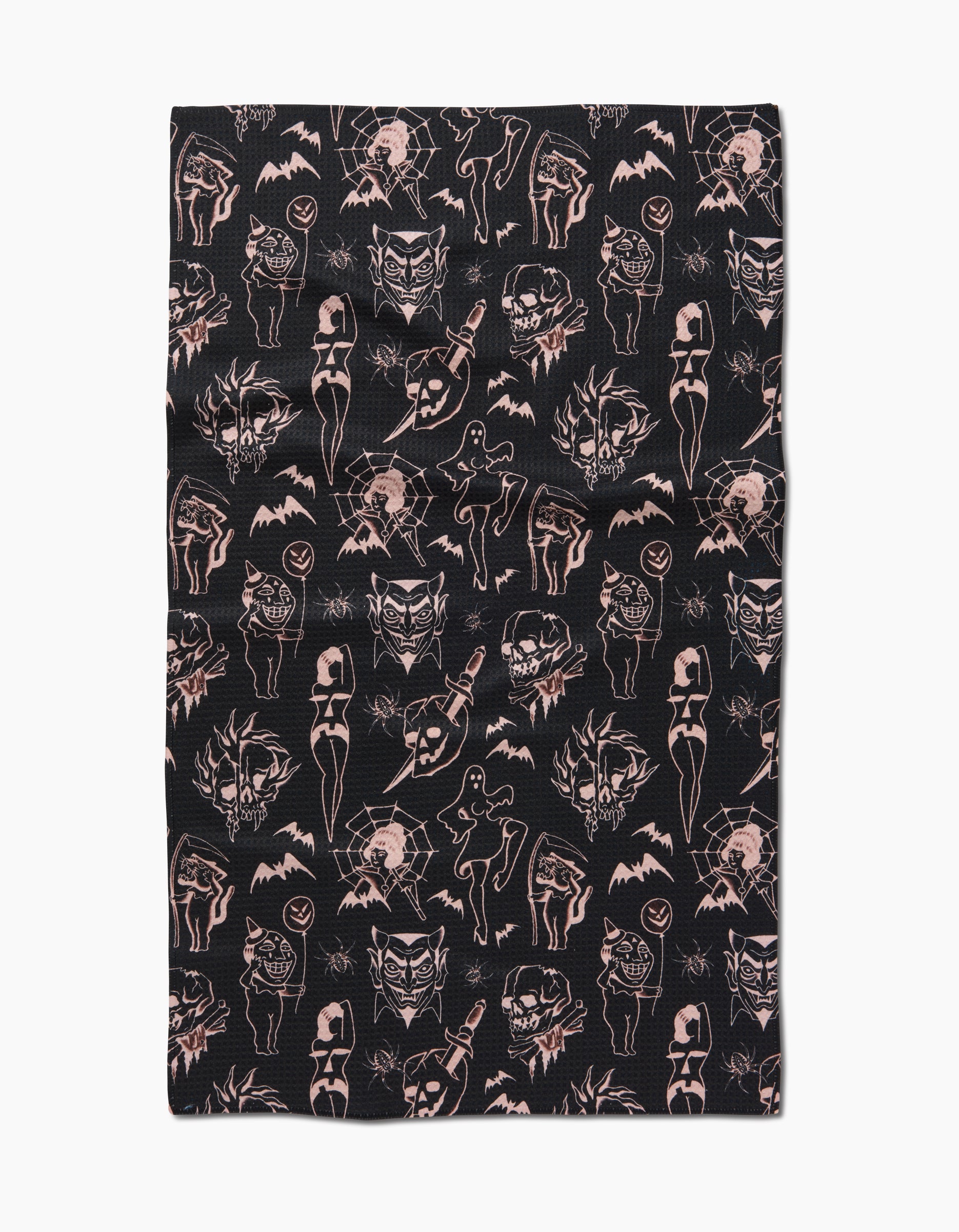 The “Halloween Flash” tea towel by Cole Strem features black Geoweave fabric with a vintage, gothic pattern of pink tattoo-style skulls, cats, bats, roses, women, and daggers for a bold statement piece.