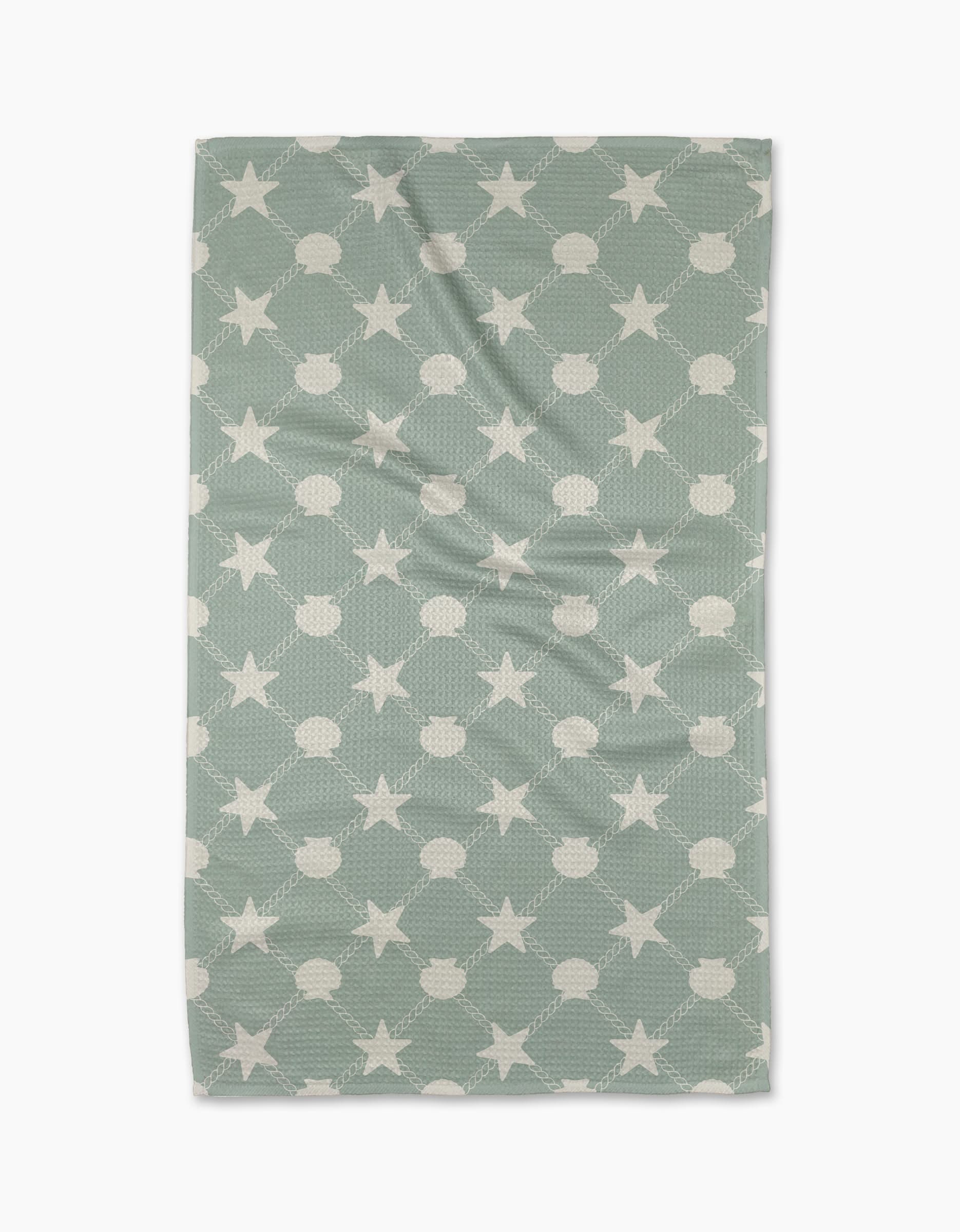 The Geometry Harbor Haven towel is rectangular and light blue-green, made from ultra-absorbent Geoweave fabric with a white star and circle pattern, shown flat on a white background.