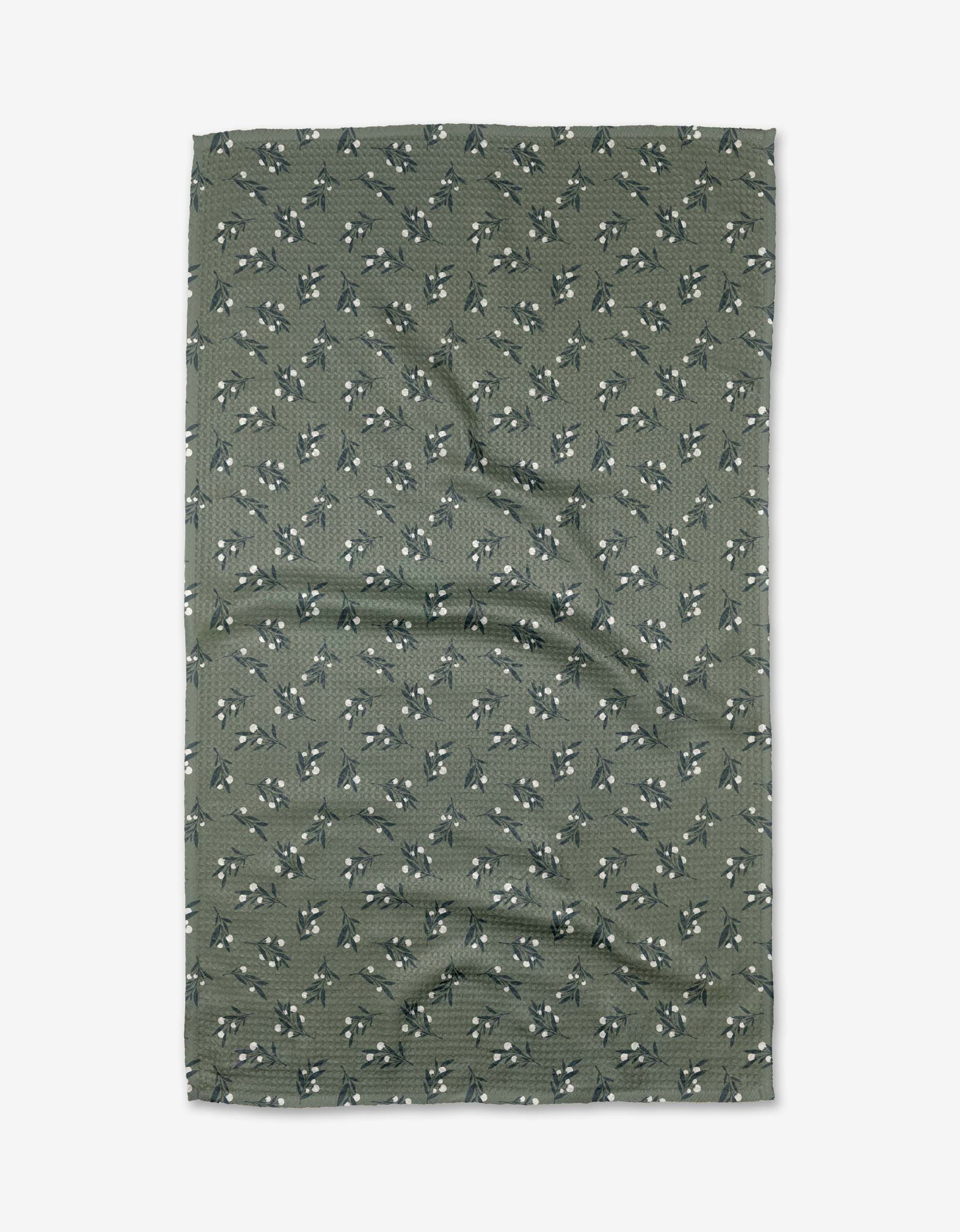 A green rectangular Harvest Berries tea towel by Charlie Rowan Designs, made of Geoweave fabric and featuring a small white and blue floral pattern, is shown laid flat with slight wrinkles visible.