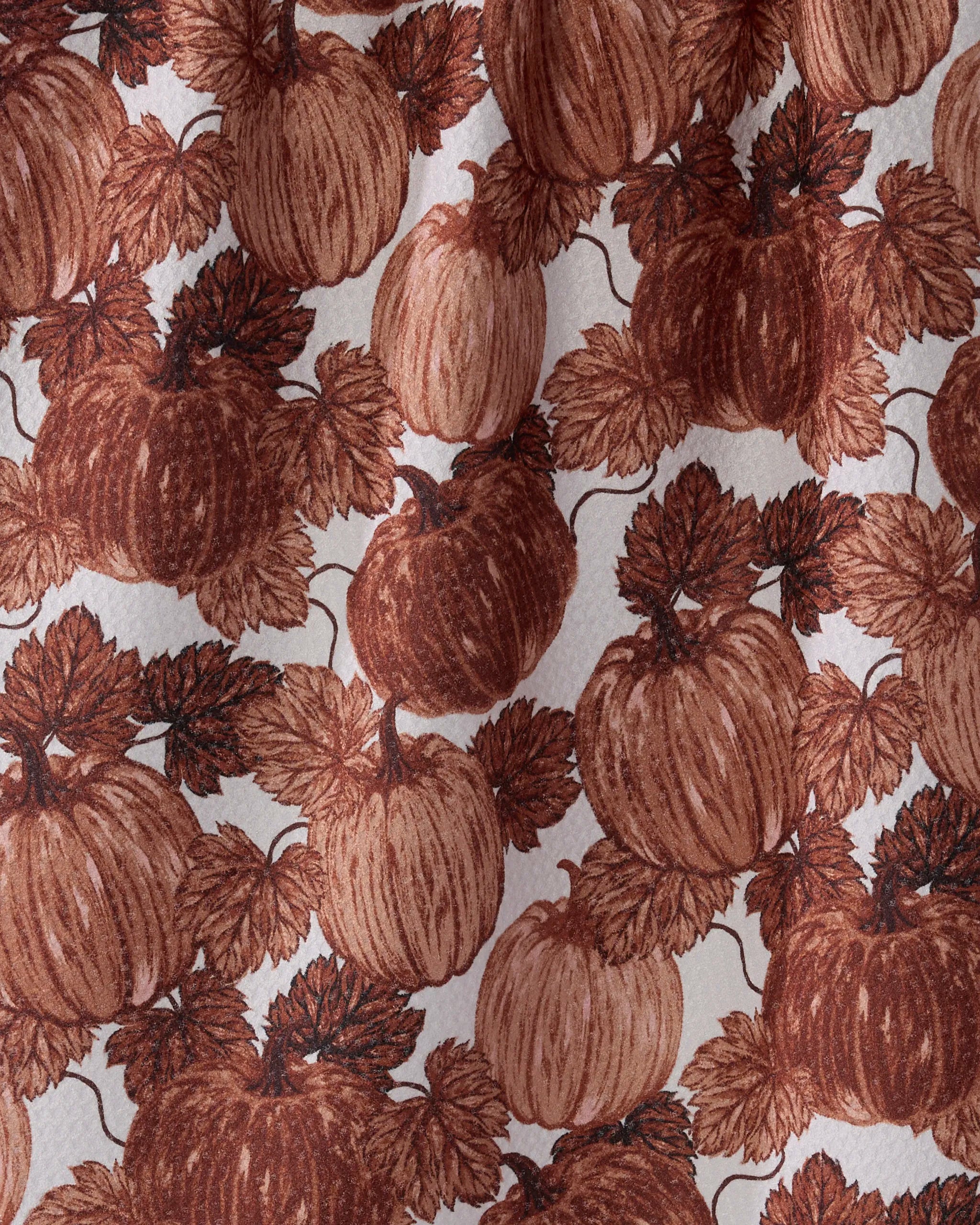 The Geometry Harvest Moon kitchen towel features a hand-drawn pattern of brown pumpkins and leaves on a light background, offering an eco-friendly, ultra-absorbent, vintage look ideal for stylish kitchens.
