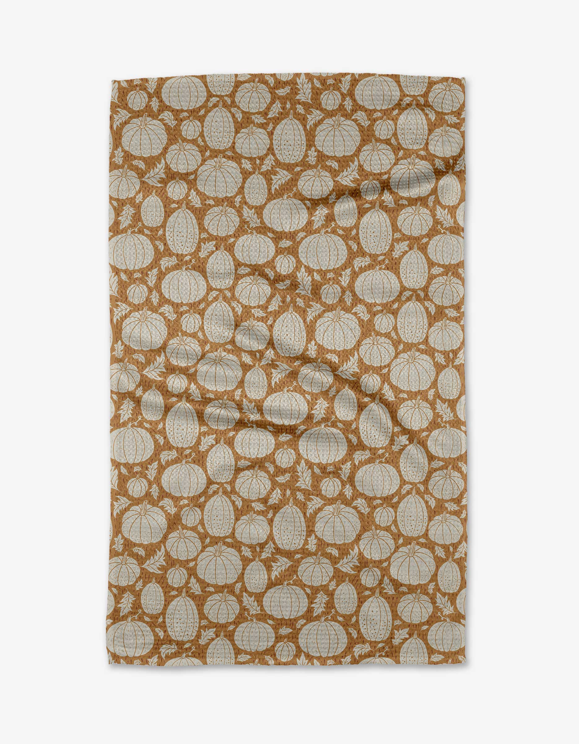 The Danelys Sidron Harvest Pumpkin Patch tea towel is made from eco-friendly Geoweave fabric and displays white pumpkin outlines on a brown background. The slightly wrinkled towel is shown laid flat on a white surface.