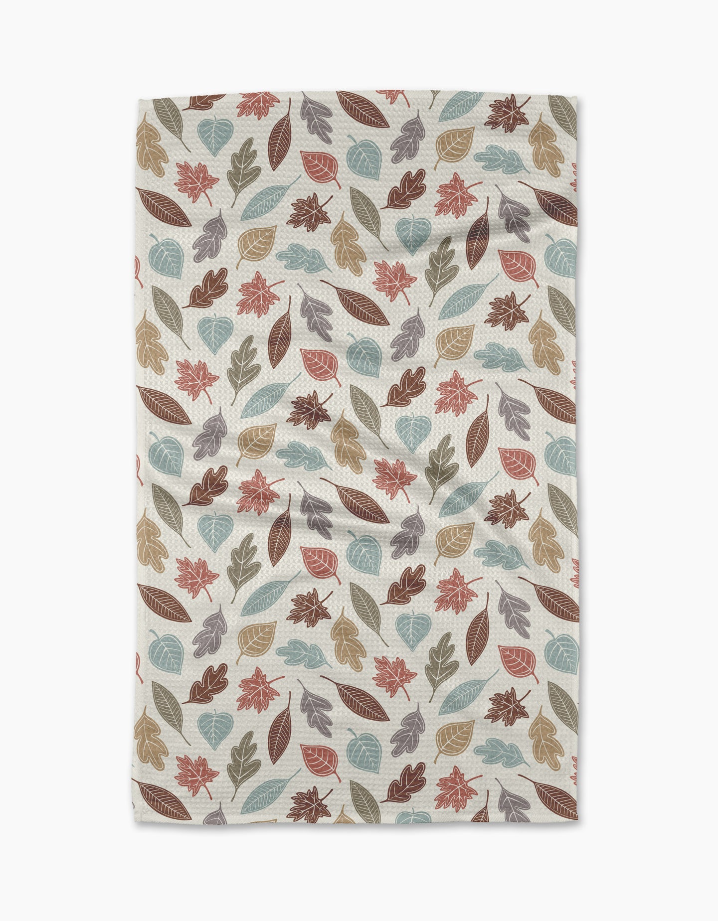 The Harvest Scatter tea towel by Sarah Daugherty features autumn leaves in brown, orange, teal, and beige on cream. Made from recycled materials, its slightly wrinkled finish gives a cozy, lived-in look.