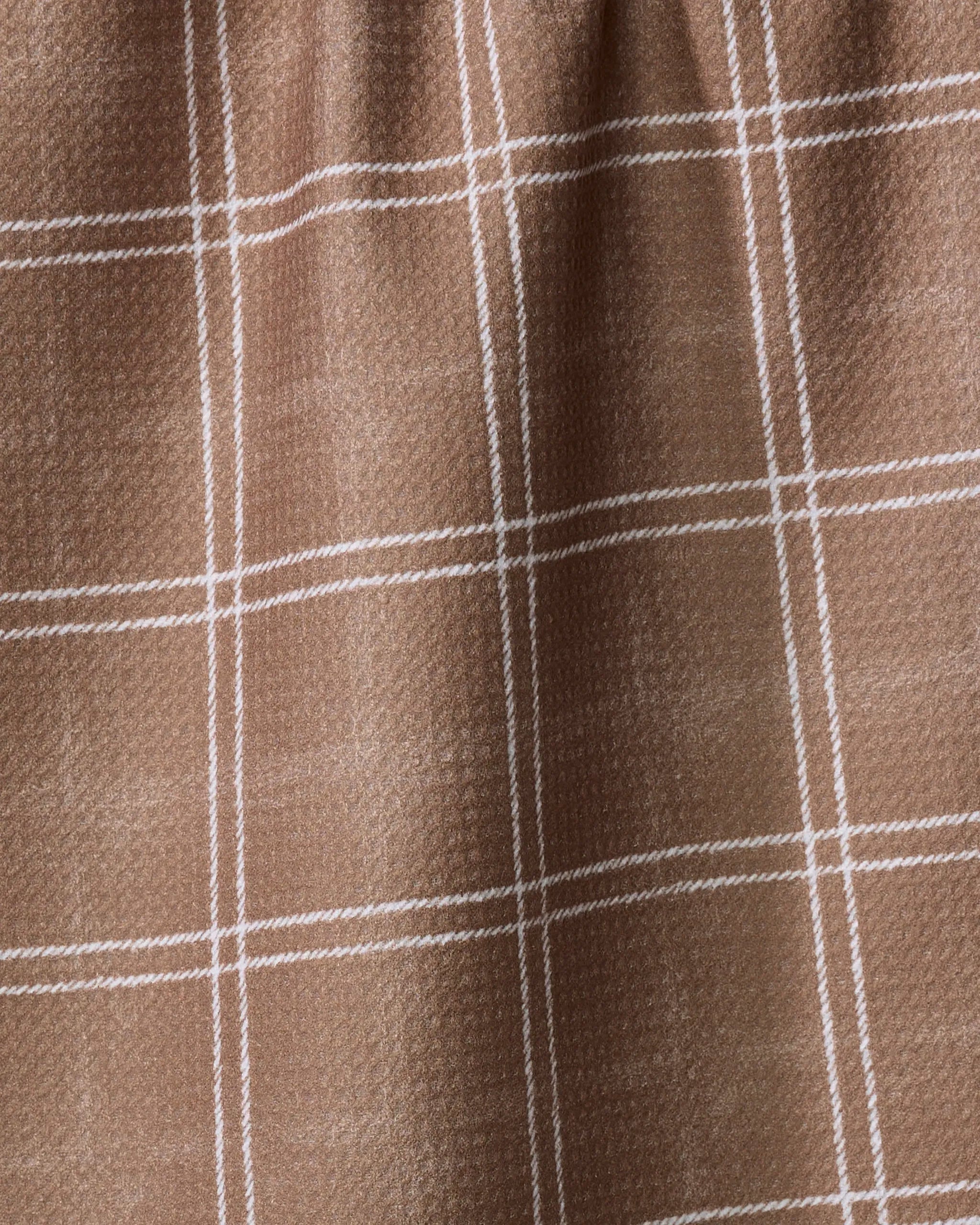 Close-up of Geometry's Hearth Chestnut tea towel, made from recycled materials in a brown hue with a white plaid grid and a subtly textured fabric.