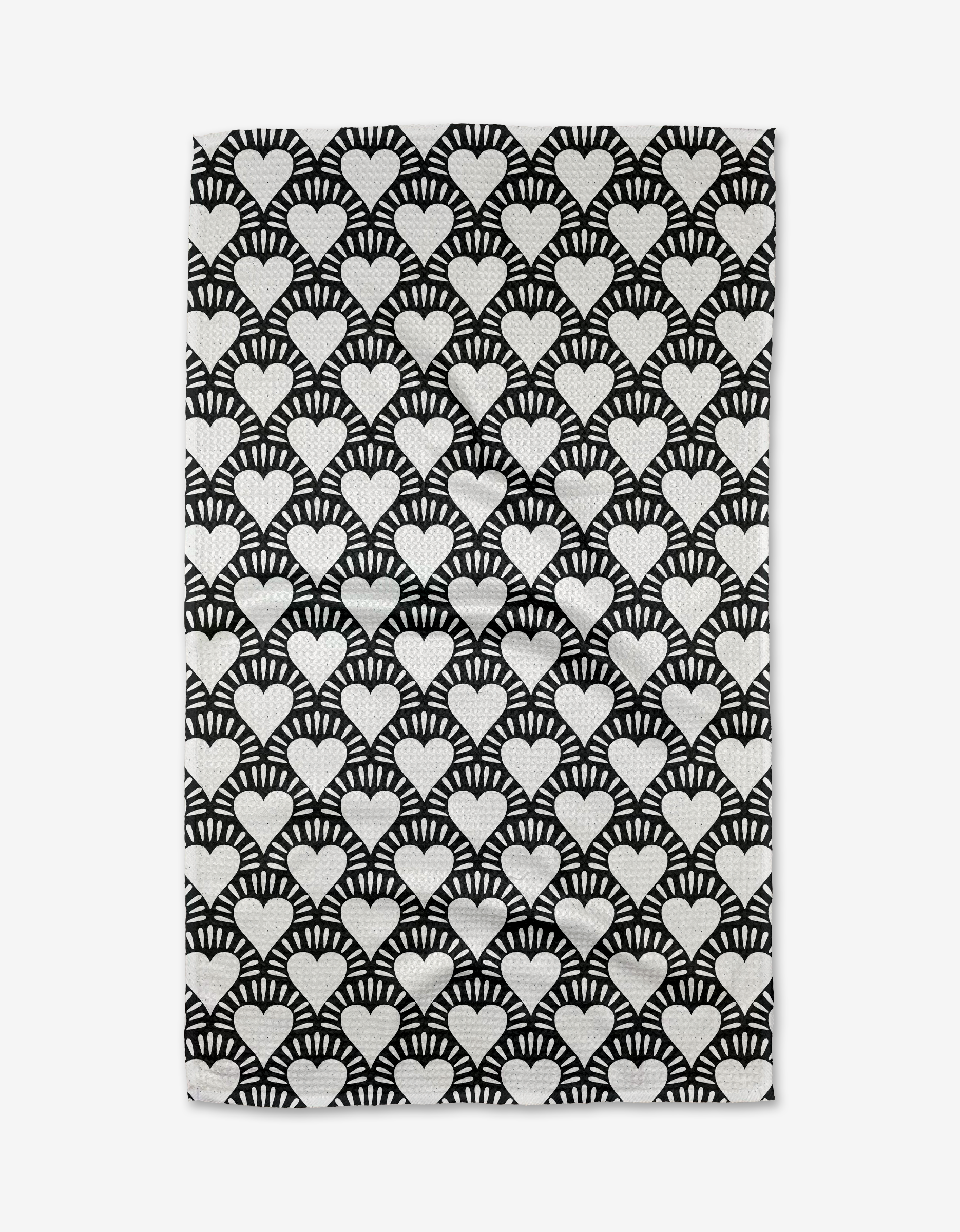 The Heartthrob Onyx tea towel by Charlie Rowan Designs features rows of white hearts with radiating lines on a black background, made from recycled materials.