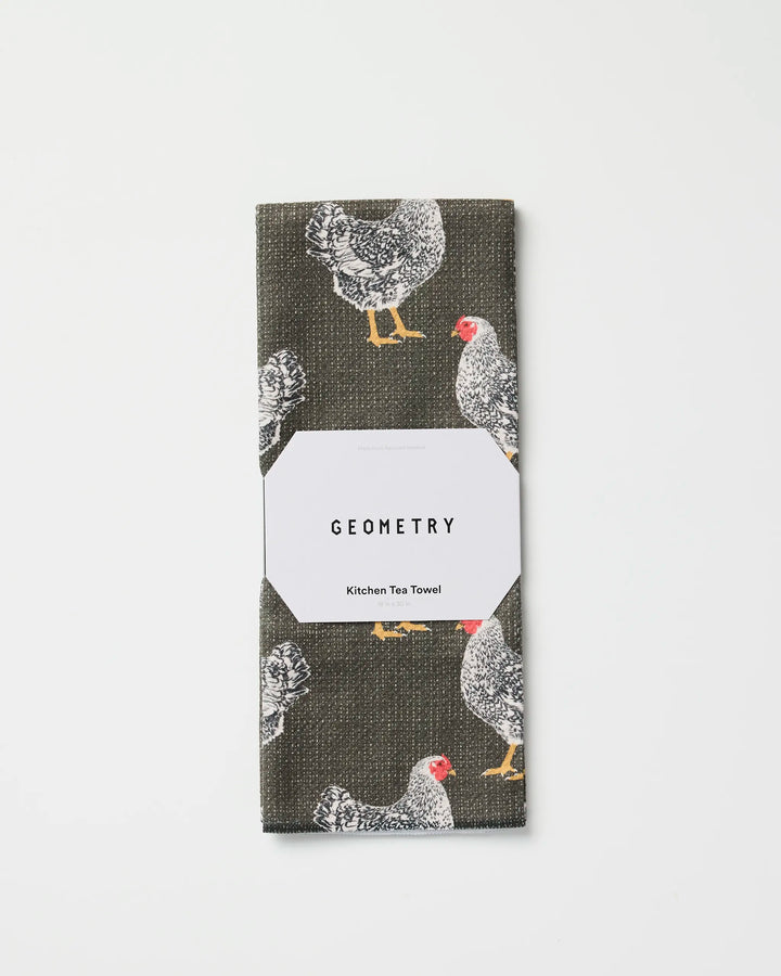 A folded ultra-absorbent Geometry tea towel called "Hen House," featuring illustrated chickens, made from recycled materials and packaged with a white Geometry Kitchen Tea Towel label on a white background.