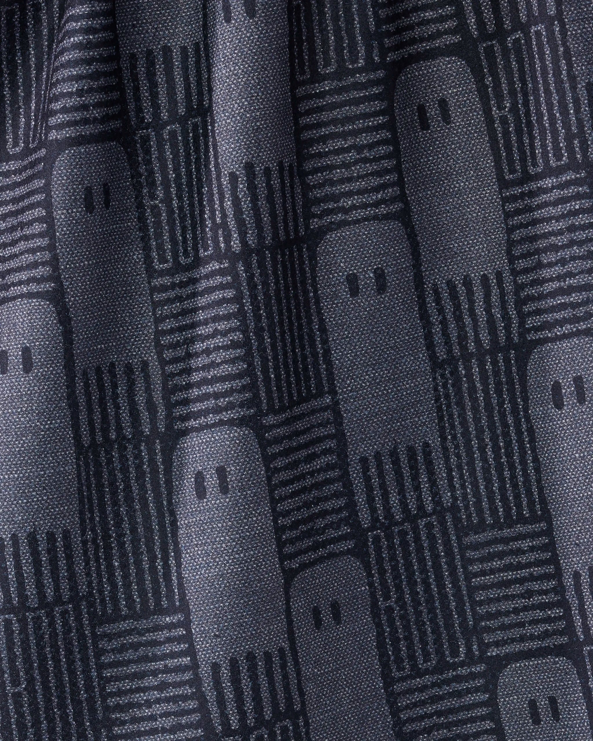 Close-up of Geometry's "Hide and Shriek" kitchen towel, made from recycled materials. It showcases a repeating pattern of simple ghost-like shapes and parallel lines in dark gray and black on slightly wrinkled fabric.