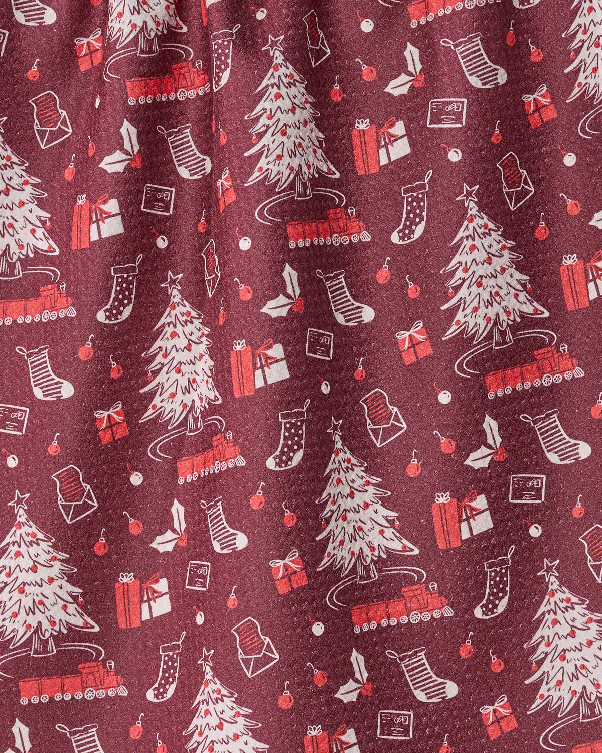 Holiday Jubilee by Geometry features a burgundy fabric adorned with a playful, repeating pattern of white Christmas trees, red gifts, stockings, holly, ornaments, and sleds. Crafted from recycled materials, this whimsical design is ideal for a holiday-themed tea towel.