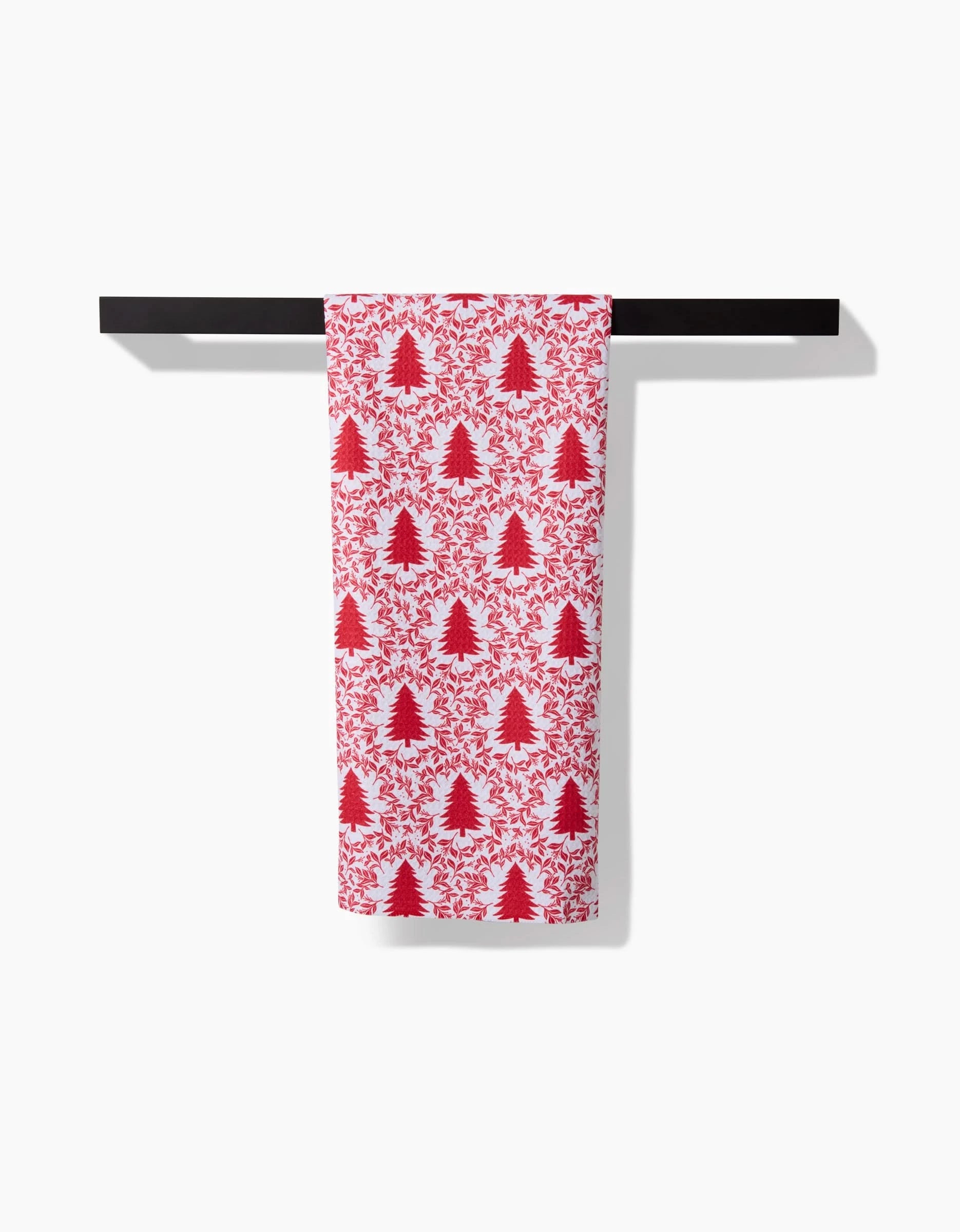 The Holiday Tree tea towel by Charlie Rowan Designs is an ultra-absorbent white towel featuring a festive red Christmas tree and holly pattern—perfect for adding holiday cheer to your kitchen.
