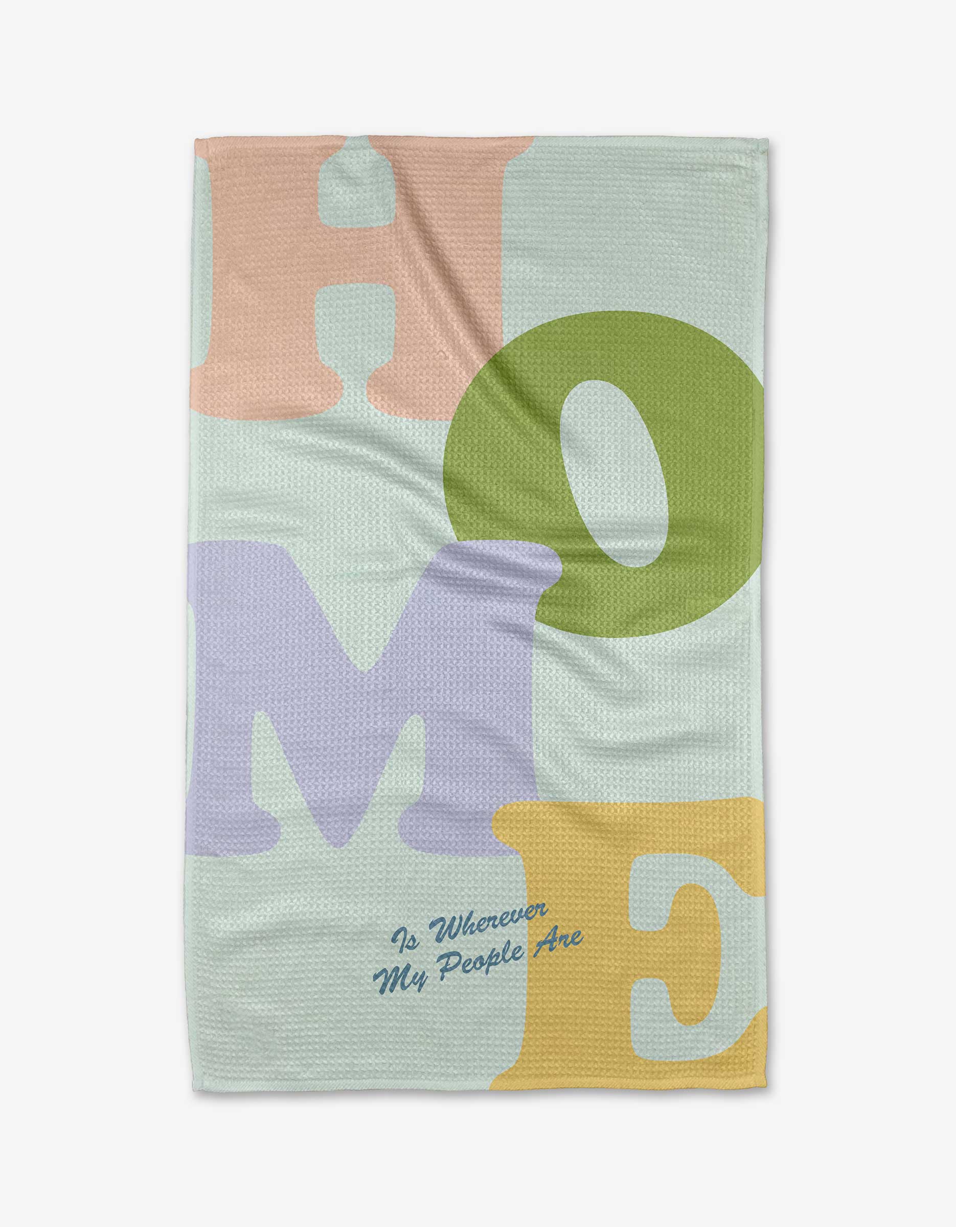 The Home tea towel by Quotes by Christie features large pastel letters spelling HOME in pink, green, purple, and yellow on recycled fabric, with “Is Wherever My People Are” in small blue cursive underneath.