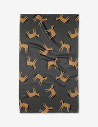 The Coit Creative Horses blanket is dark gray, made from recycled materials, and showcases a repeating pattern of stylized brown horses in various directions.
