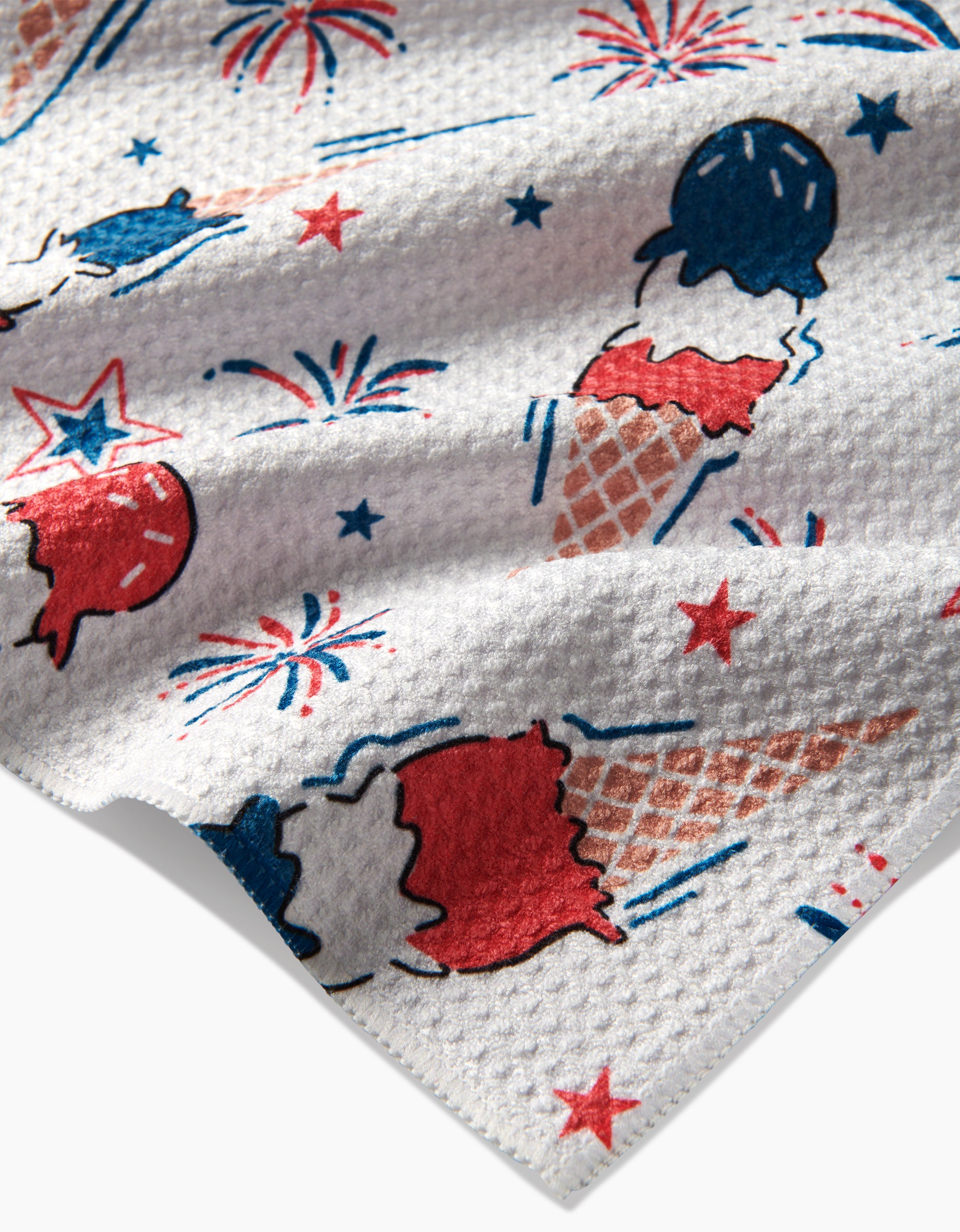 Add cheer to your kitchen with Hufton Studios Ice Cream Celebration Tea Towel—a textured white, recycled piece featuring red, white, and blue ice cream cones, popsicles, fireworks, and stars in a festive patriotic pattern.