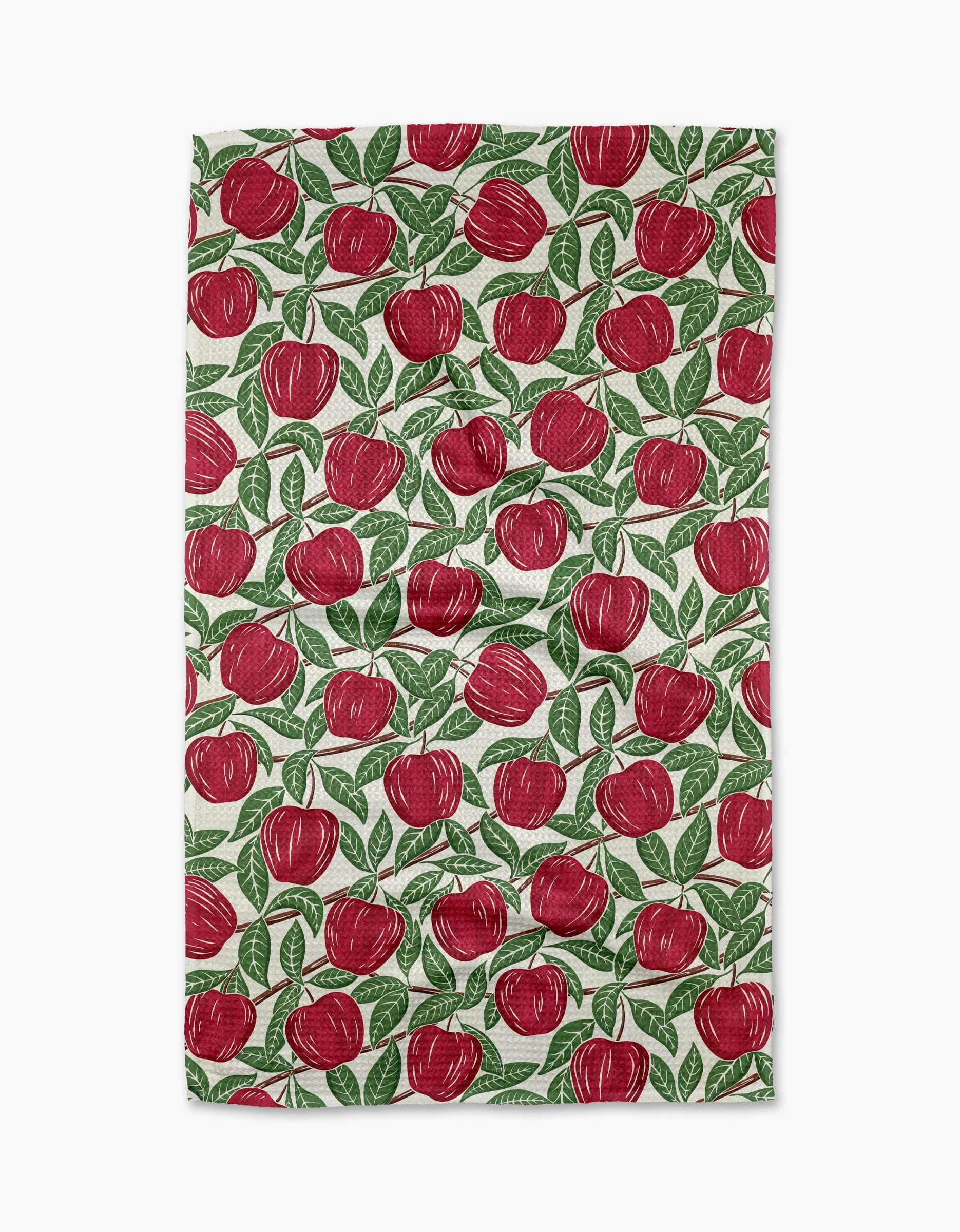 The In the Apple Tree towel by Sarah Daugherty is a rectangular, quick-drying towel with a white background and a repeated red apple with green leaves pattern.