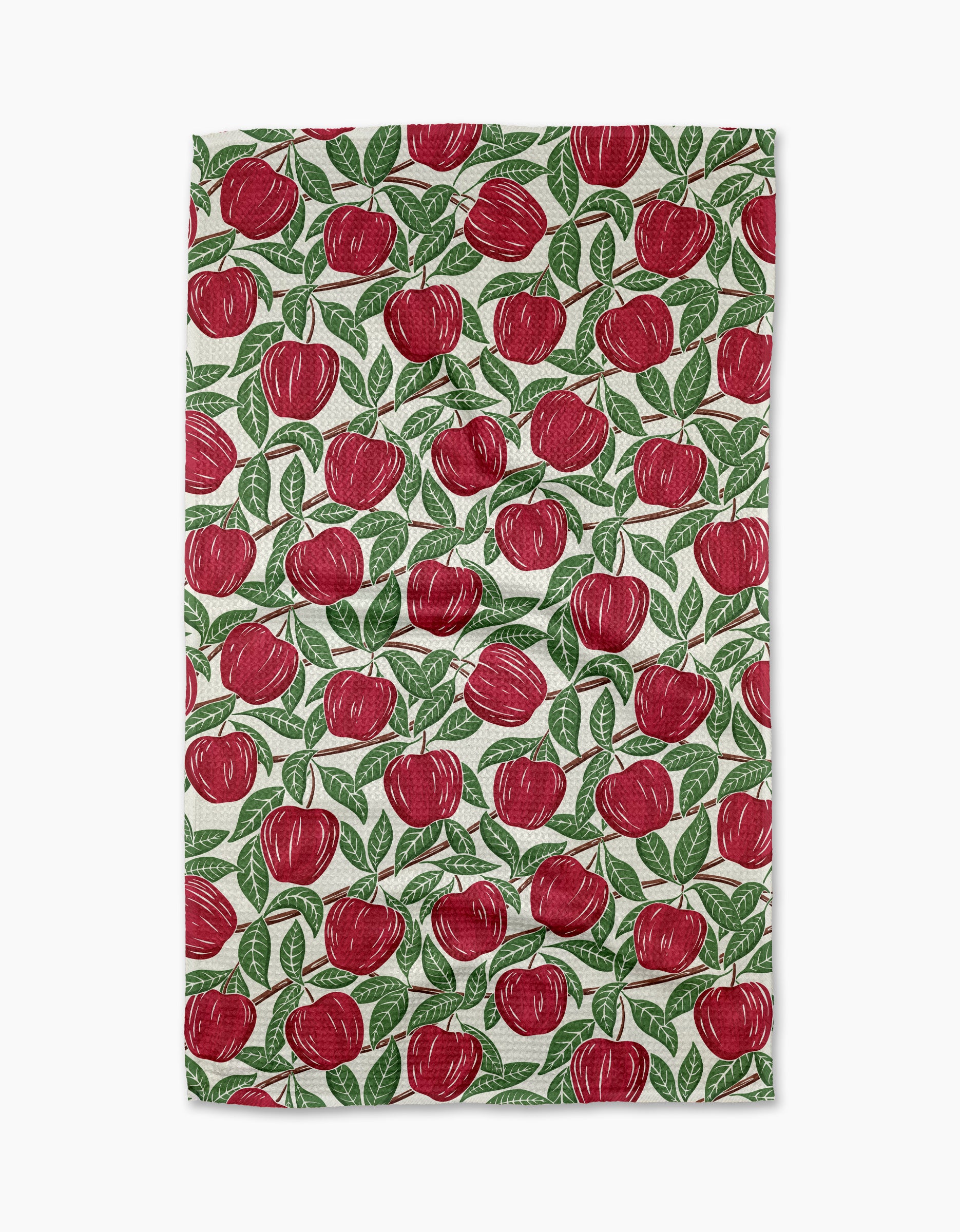 The In the Apple Tree towel by Sarah Daugherty is a rectangular, quick-drying towel with a white background and a repeated red apple with green leaves pattern.