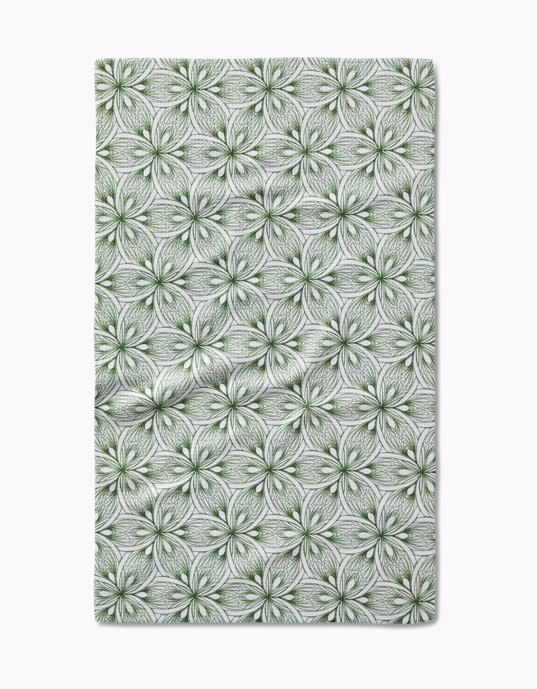 The Interlaced Petals tea towel by Marta Harvey features a repeating pattern of green, hand-drawn floral designs with intricate lines on a white background.