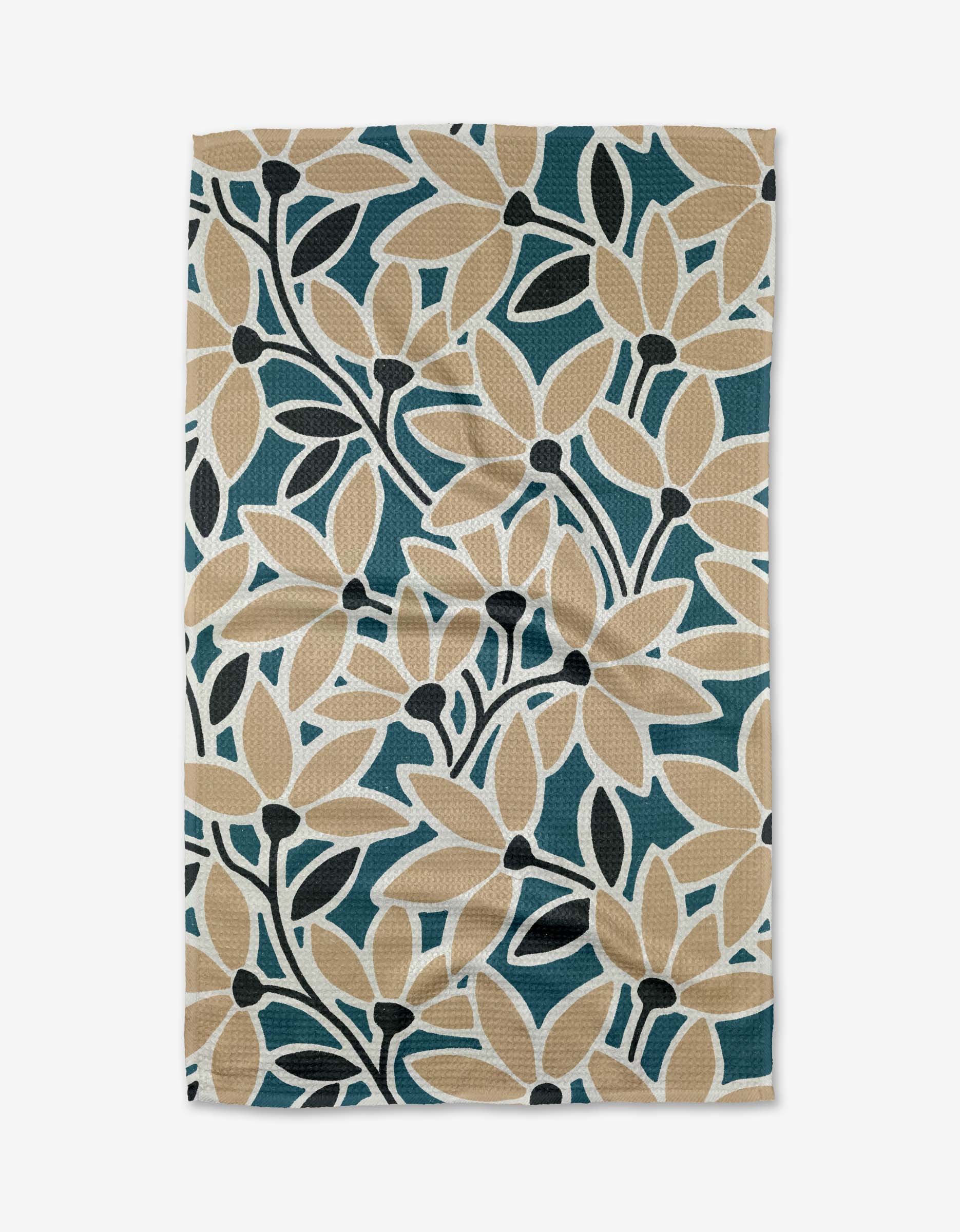 The Janine towel by Amy MacCready features a bold botanical pattern with beige, dark green, and black leaves on white Geoweave fabric, giving it a textured, slightly wrinkled, and eco-friendly appearance.