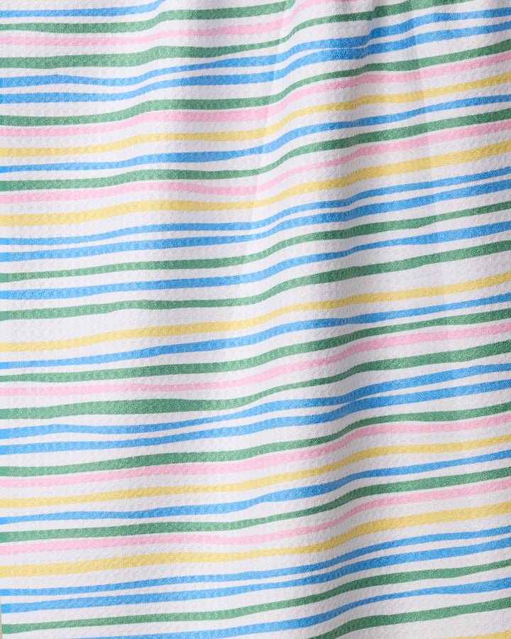 A close-up of Geometry’s Jubilation towel showcases its absorbent, slightly textured fabric with horizontal pastel stripes—blue, green, yellow, and pink—on white. Charming and practical, it's perfect for any kitchen.