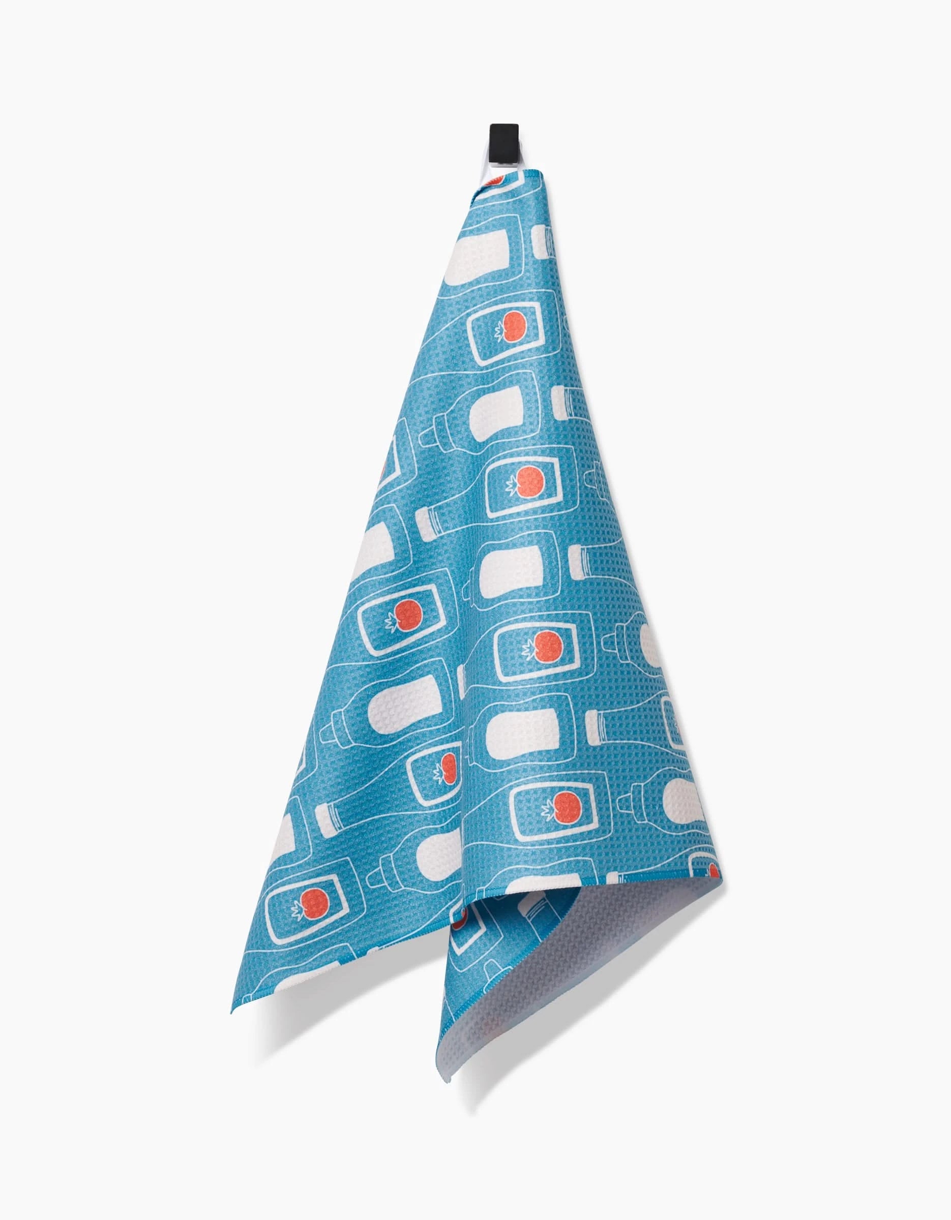The July Squeeze by Sara Mari is a blue kitchen towel made from ultra-absorbent Geoweave fabric, with a water bottle and red sun pattern, hanging from a black loop on a white background.