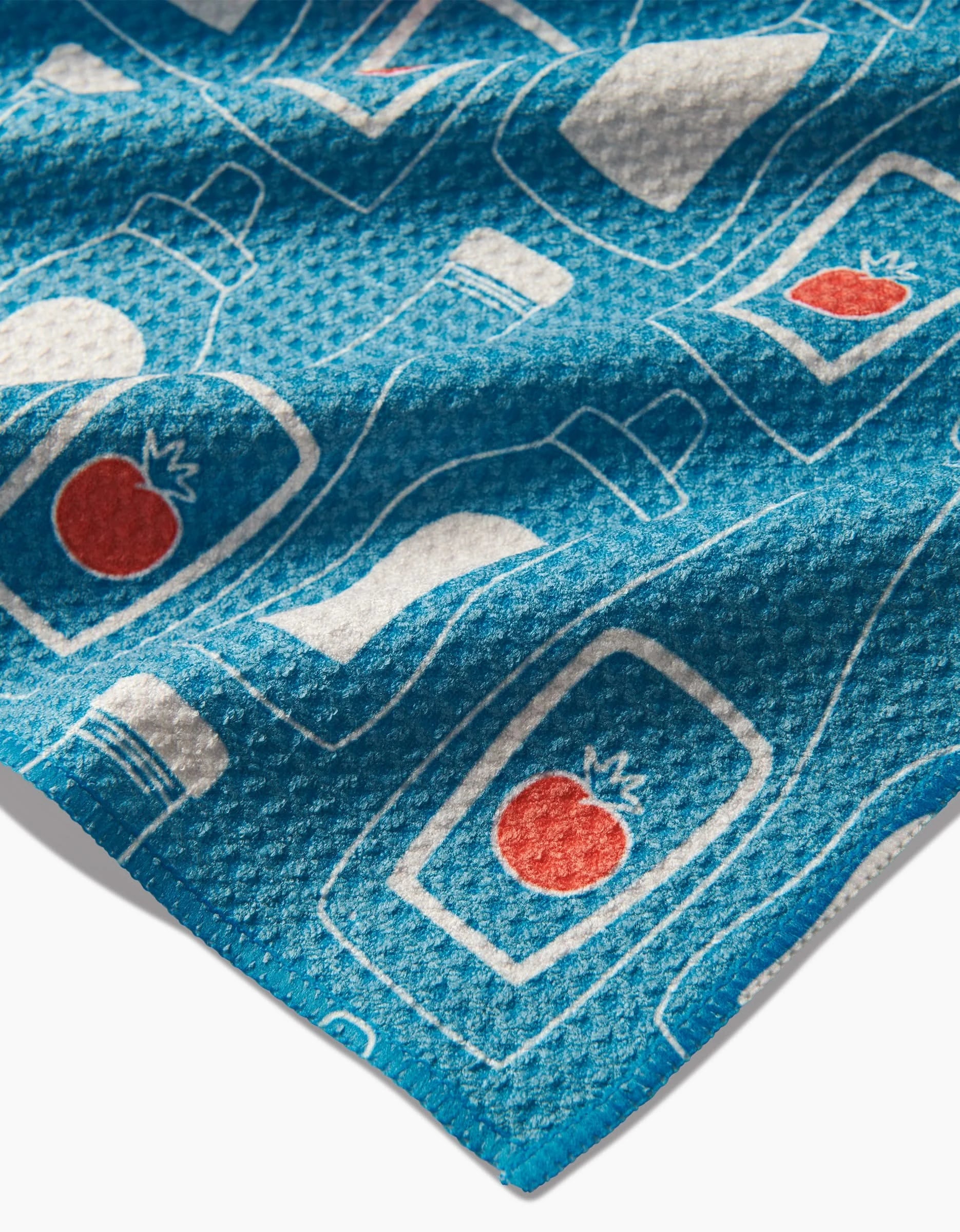 The Sara Mari July Squeeze is a blue, ultra-absorbent Geoweave cloth featuring white outline condiment bottles, some labeled with a red tomato graphic.
