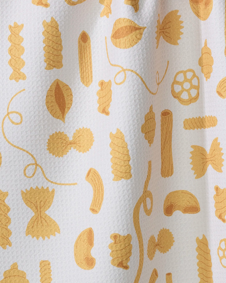 The Vaishali Design Studio 'Just Add Sauce' tea towel features playful yellow penne, fusilli, farfalle, rotini, and spaghetti shapes scattered on white textured fabric. This ultra-absorbent towel adds fun to your kitchen.
