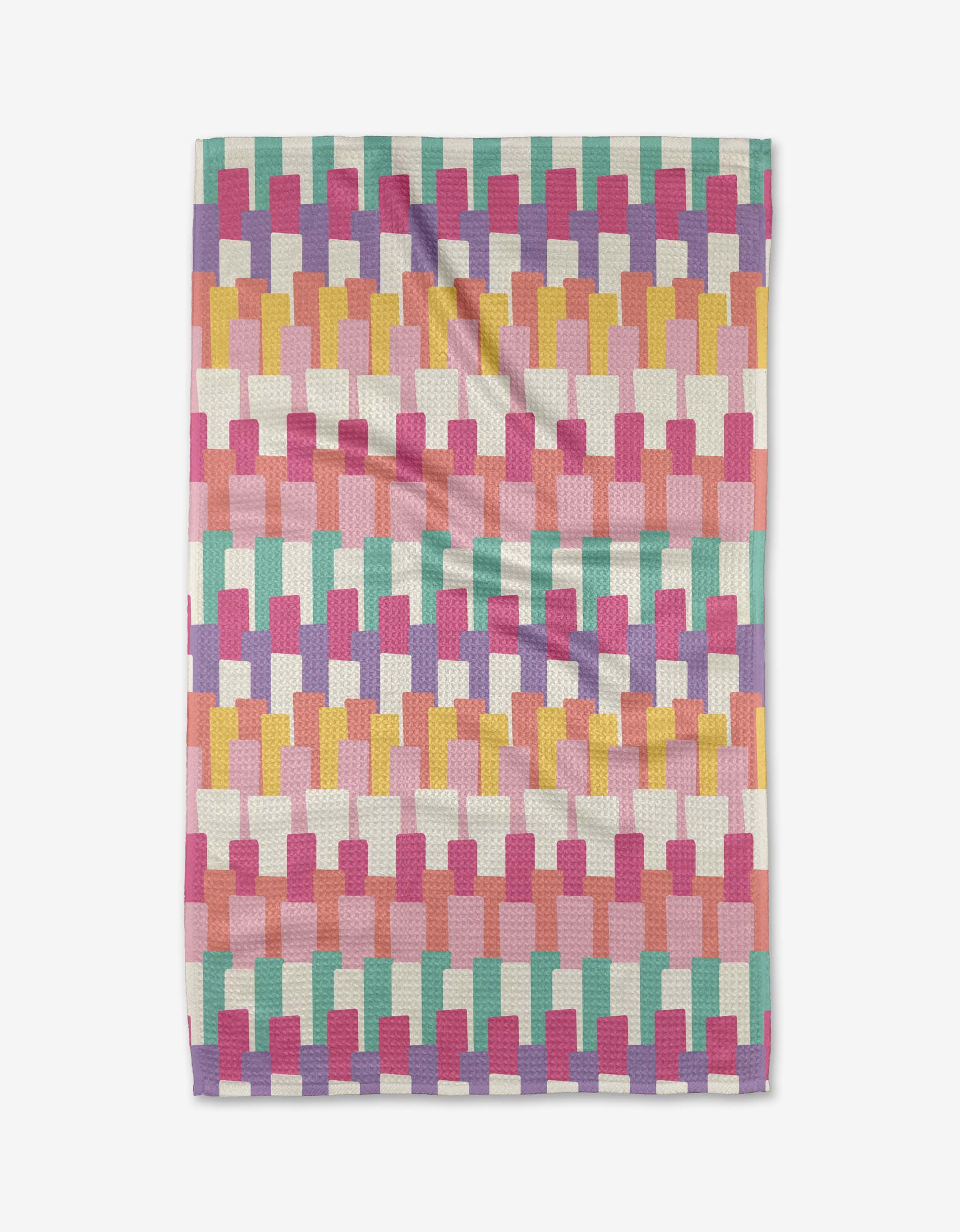 The Keys tea towel by Rebecca Bobko features a geometric, brick-like pattern in pink, mustard yellow, turquoise, coral, and white Geoweave fabric, shown flat against a white background.