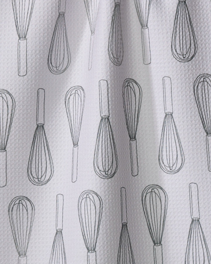 The Rosa Kichline Kitchen Whisks tea towel features a textured white design with black outlined whisks in neat vertical rows, made from quick-drying recycled materials.