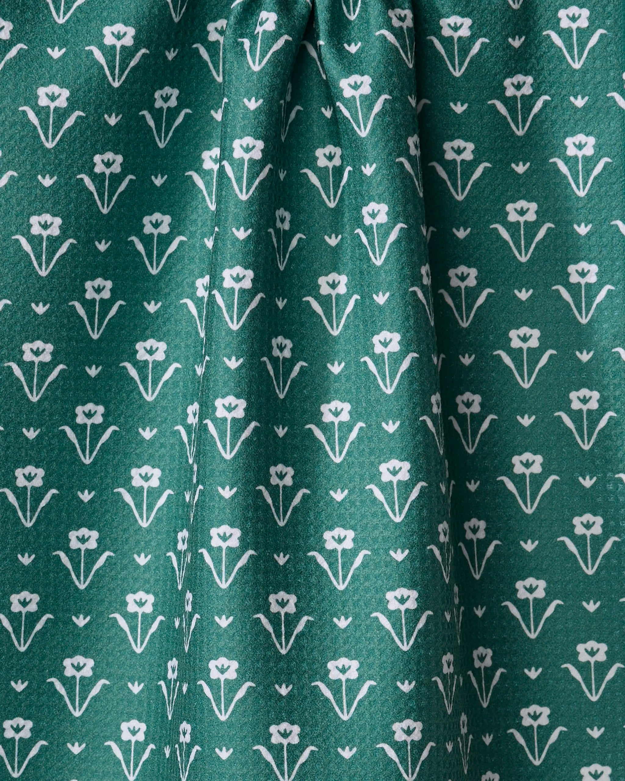 The Buy Guide's Ladylake - Evergreen dish towel features absorbent green recycled fabric with a repeating white floral pattern, stylized flowers in rows, and soft center-gathered folds for an elegant kitchen accent.