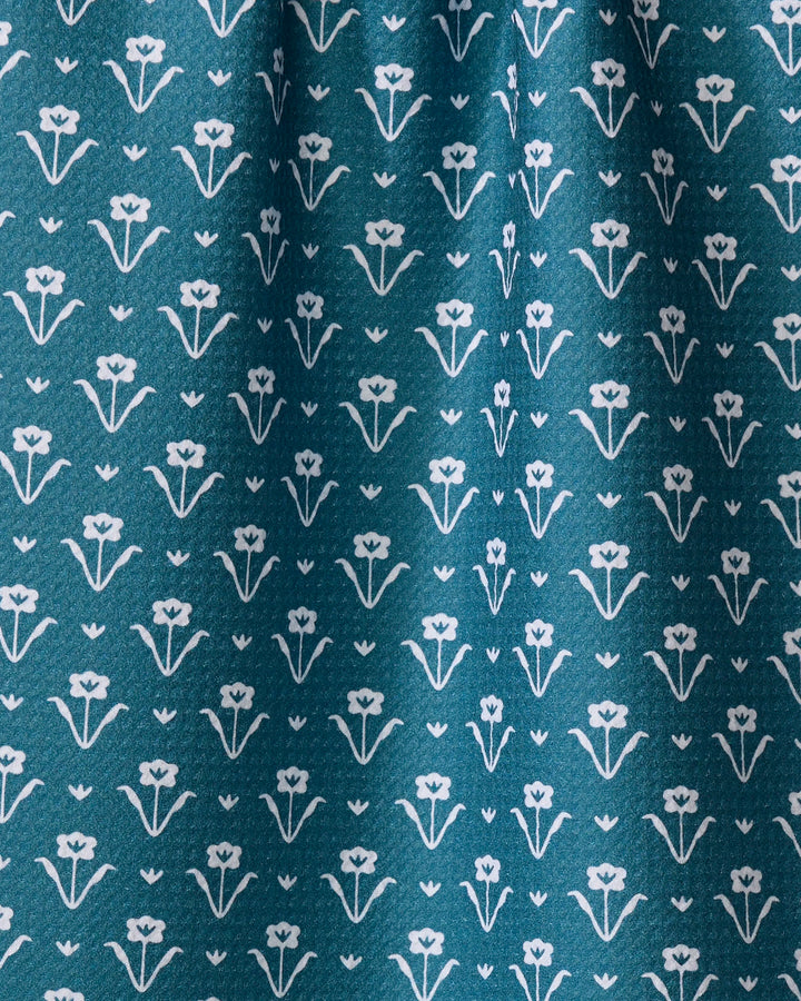 Ladylike - Emerald by The Buy Guide features teal fabric with a repeating white floral and heart motif, arranged in neat rows—ideal as an absorbent dish towel for your kitchen.