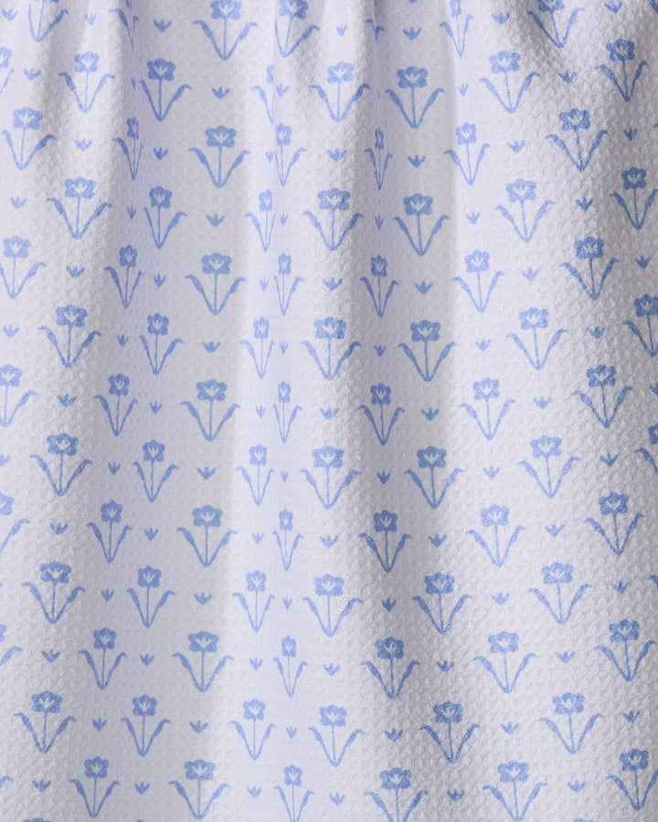 Close-up of The Buy Guide’s Ladylike Too - French Blue tea towel, featuring a light blue and white textured design with small blue floral patterns. Ultra-absorbent, the towel is shown slightly gathered at the top.