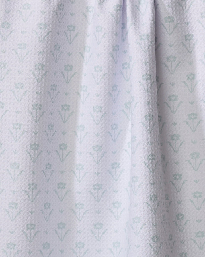 Close-up of the Ladylike Too - Mint dish towel by The Buy Guide, an absorbent recycled kitchen towel in light blue with a subtle geometric floral pattern, shown gently draped.