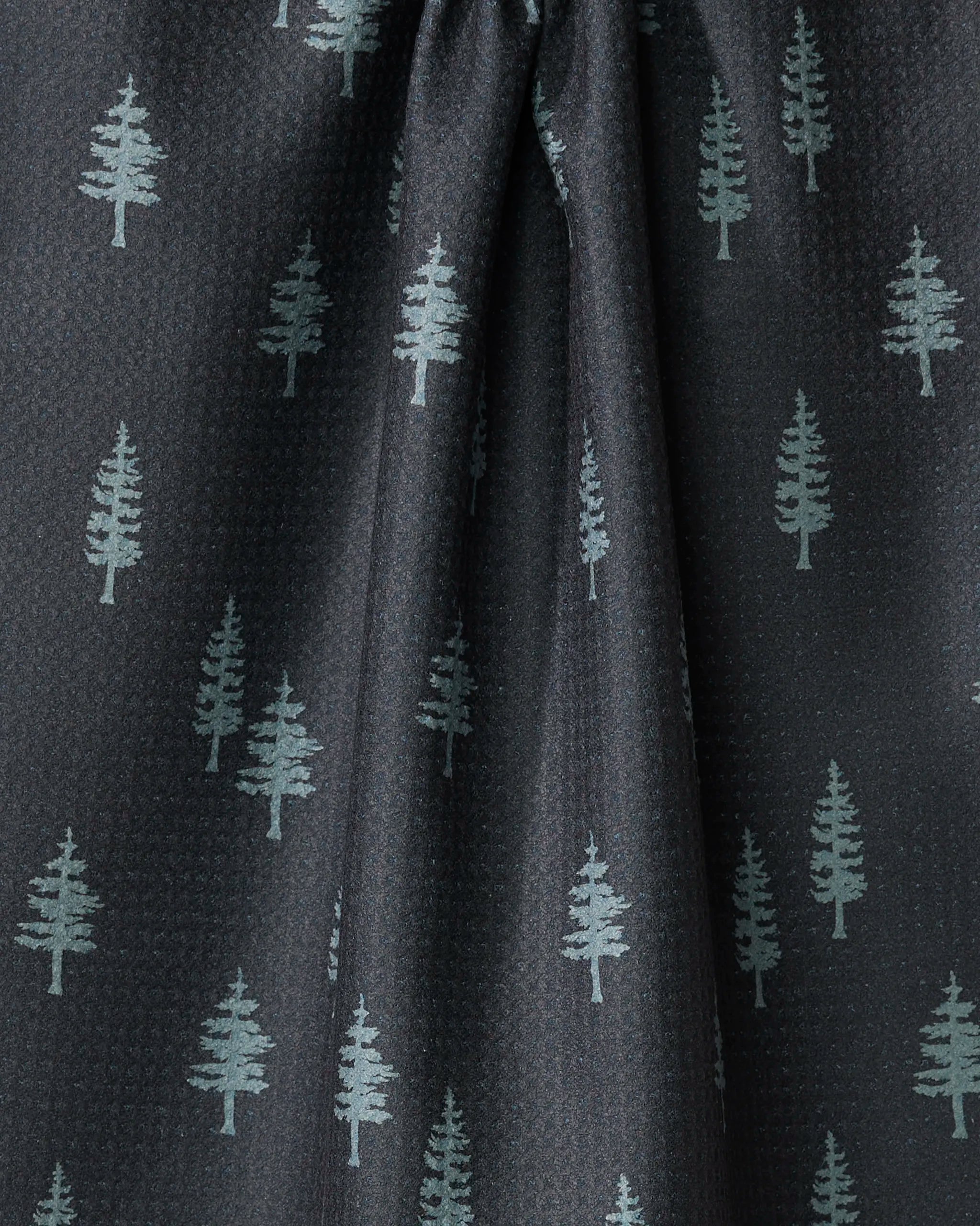 Lake Pine by Coit Creative features dark fabric with a subtle grid and repeating light green pine trees. This ultra-absorbent towel is center-gathered for soft folds—ideal as a stylish kitchen tea towel.