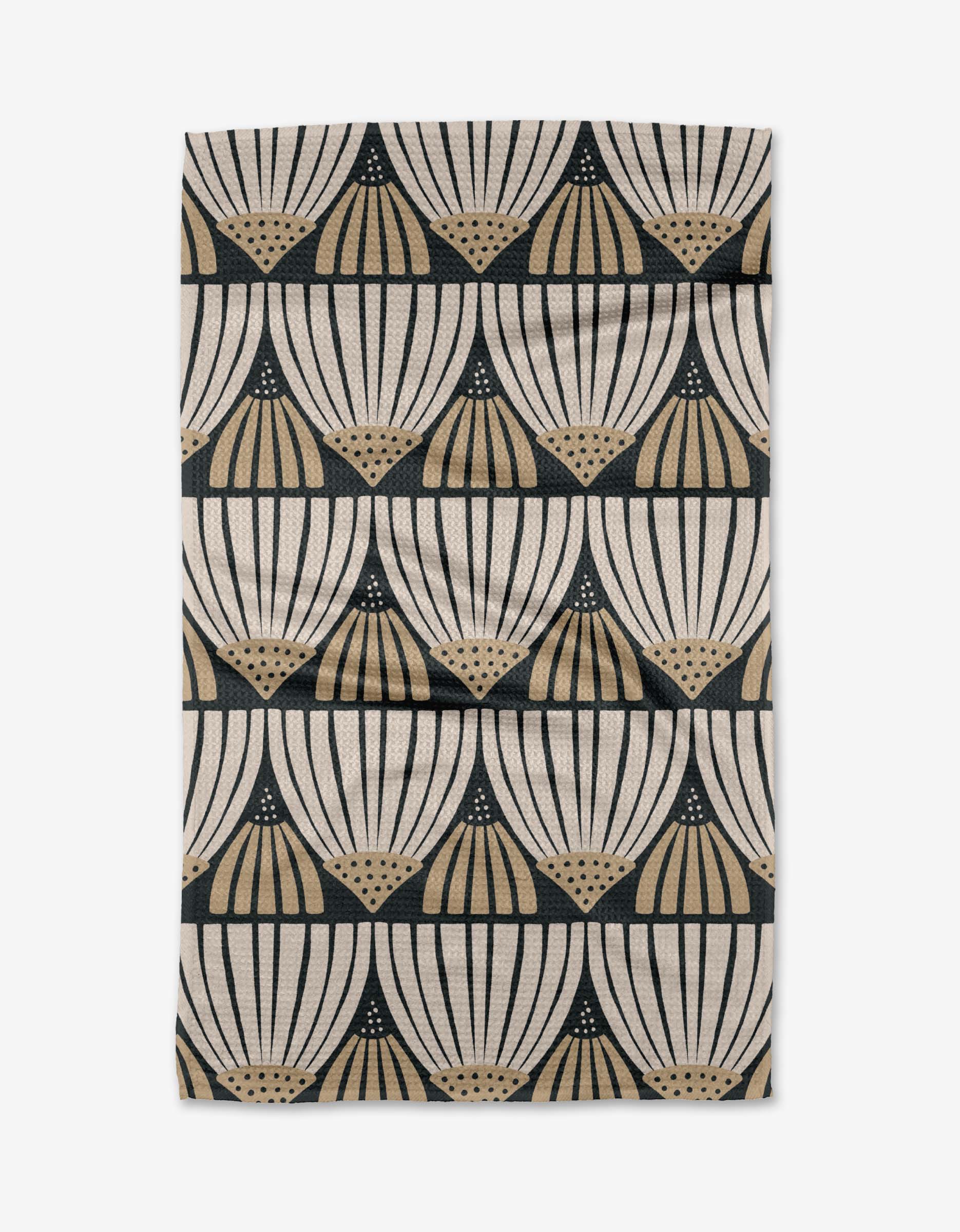 The Letitia tea towel by Amy MacCready features a cream and beige fan-like geometric pattern in black, arranged in horizontal rows. Made from recycled materials, its ultra-absorbent fabric has a slightly wrinkled look.