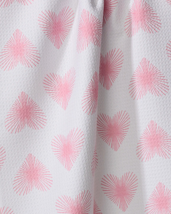 The "Life Line Hearts" towel by Hufton Studio features white textured fabric with a repeating pink heart pattern of radiating lines. Slightly gathered, this quick-drying towel is charming and practical.