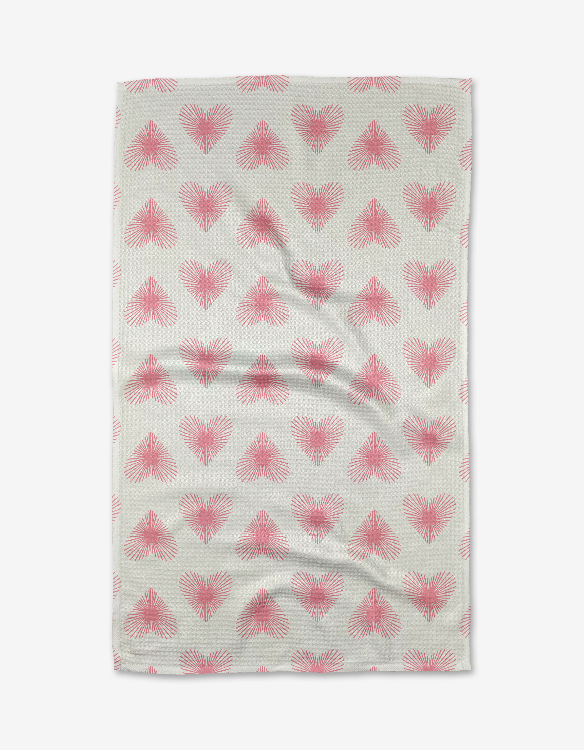 The Life Line Hearts tea towel by Hufton Studio features a beige background with rows of pink, radiating heart shapes. Made from Geoweave fabric, it has subtle wrinkles and is shown against a white background.