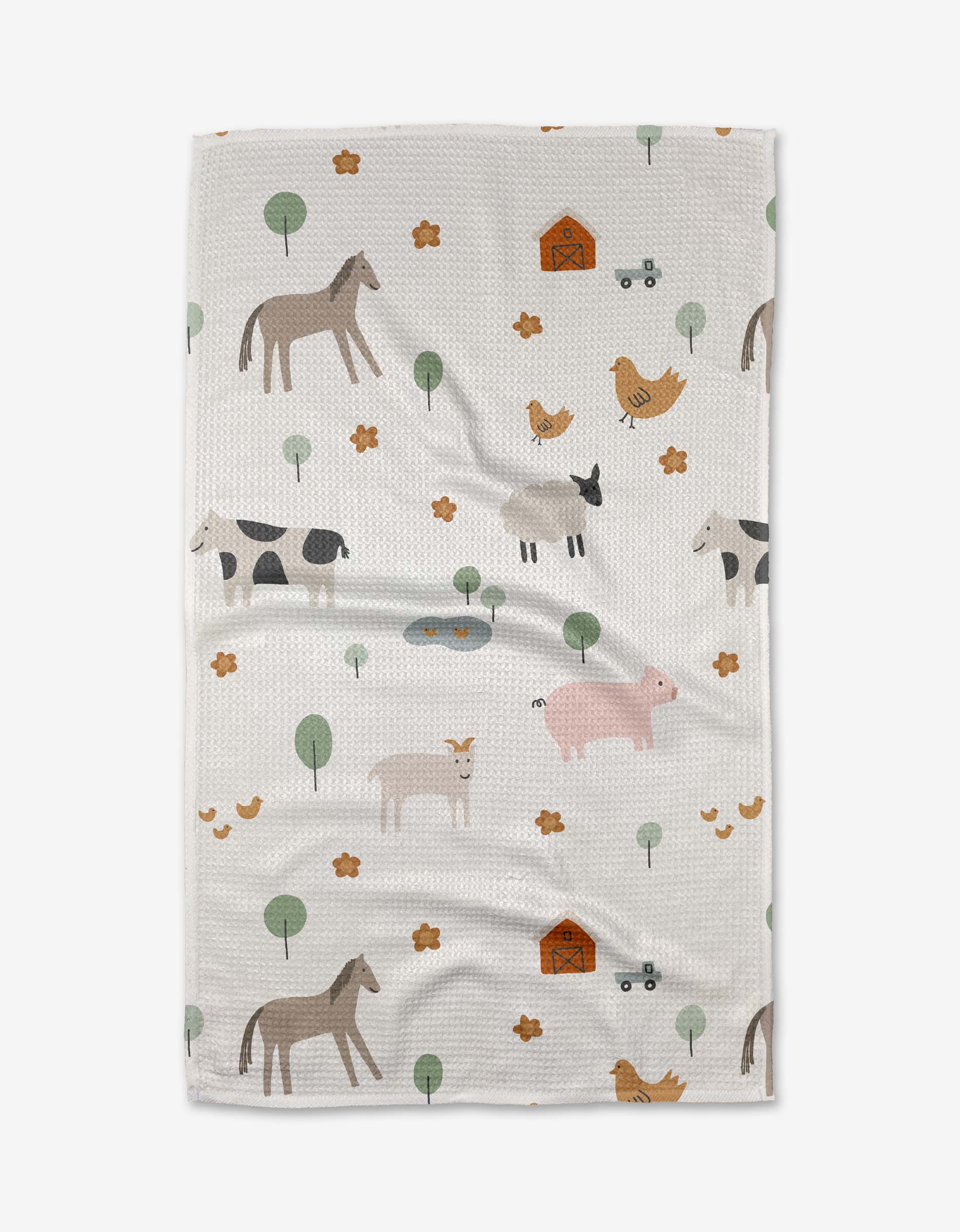 The Coit Creative Light Farm Animals tea towel is crafted from white Geoweave™ fabric and features a playful farm-themed pattern with illustrated animals, barns, trees, and small yellow flowers scattered across the surface.