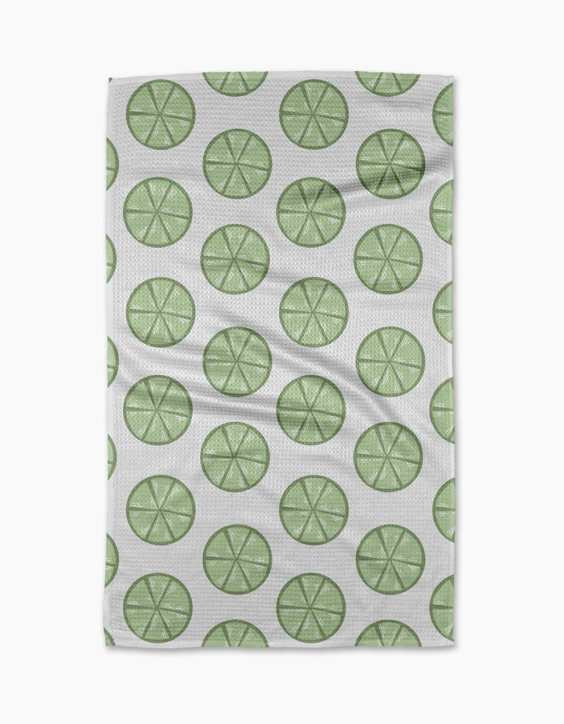 Lime Doodles by Letters By Shells is a quick-drying tea towel with a repeating pattern of green lime slices, each with visible segments, arranged in neat, evenly spaced rows.
