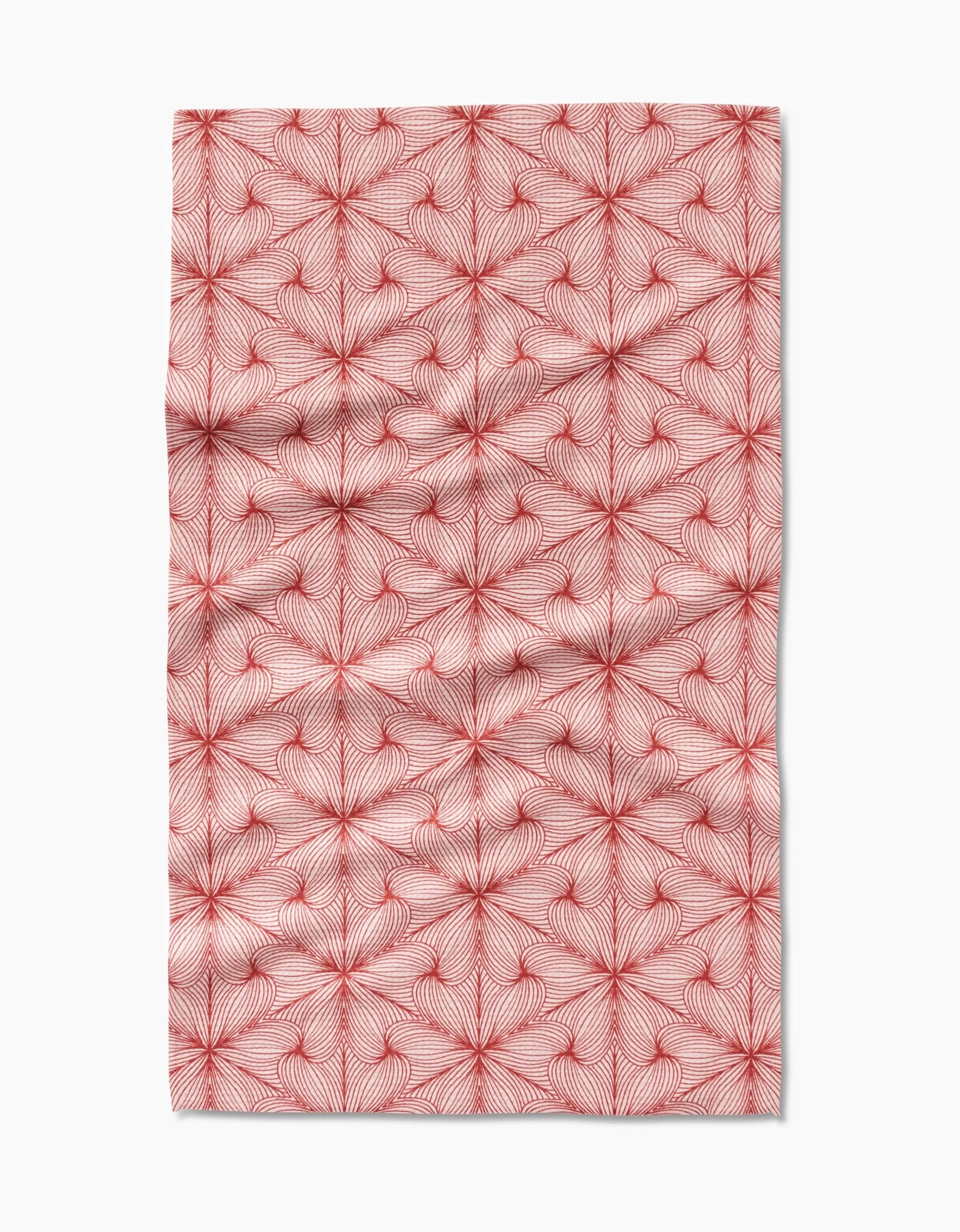 Lined by Marta Harvey is a rectangular, ultra-absorbent towel with a repeating geometric fan pattern of red radiating lines on a white background and subtle fabric creases.