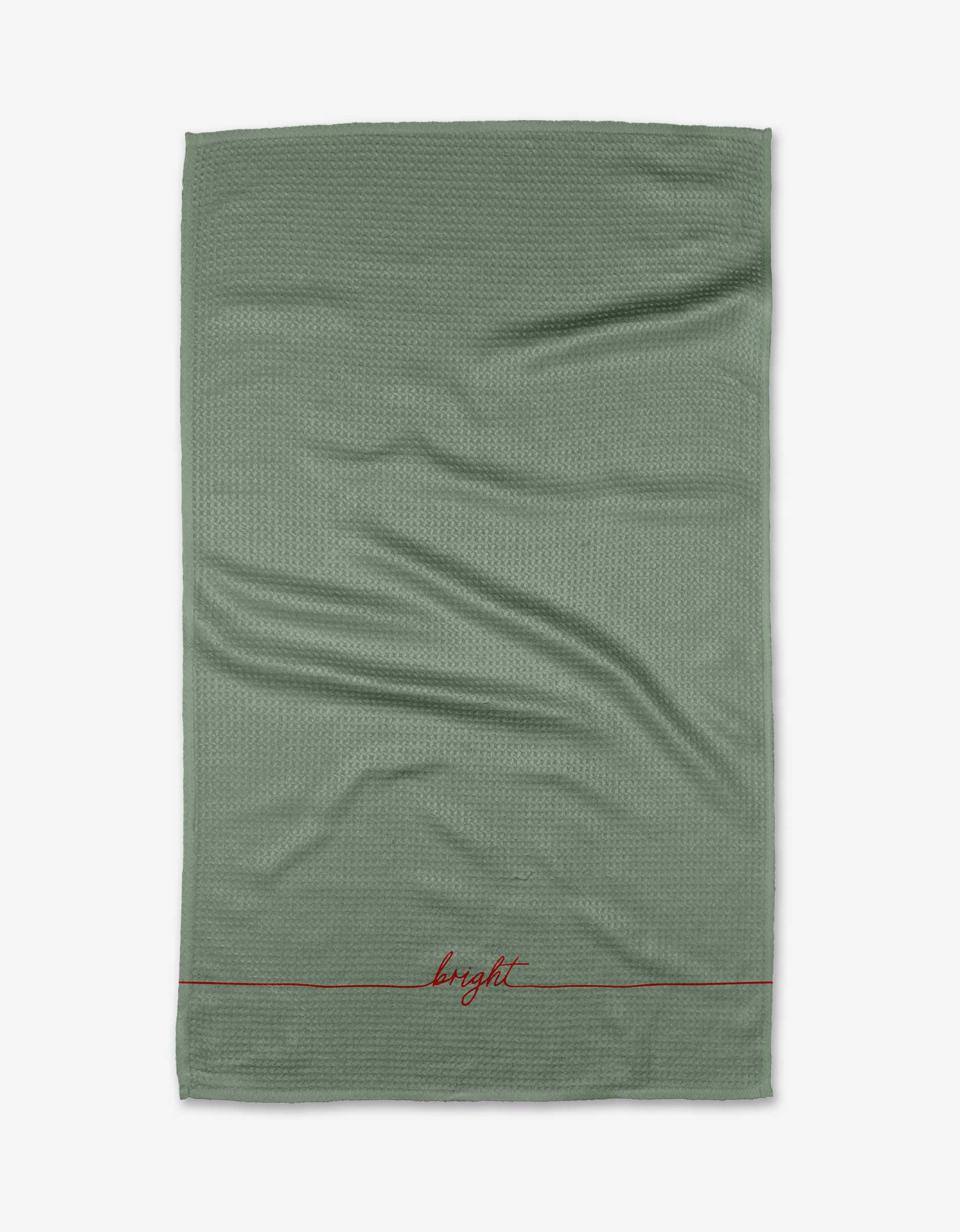 The Kailee Wright Little Elf is a green, ultra-absorbent tea towel with subtle creases and “bright” embroidered in red near the bottom edge above a thin red line.