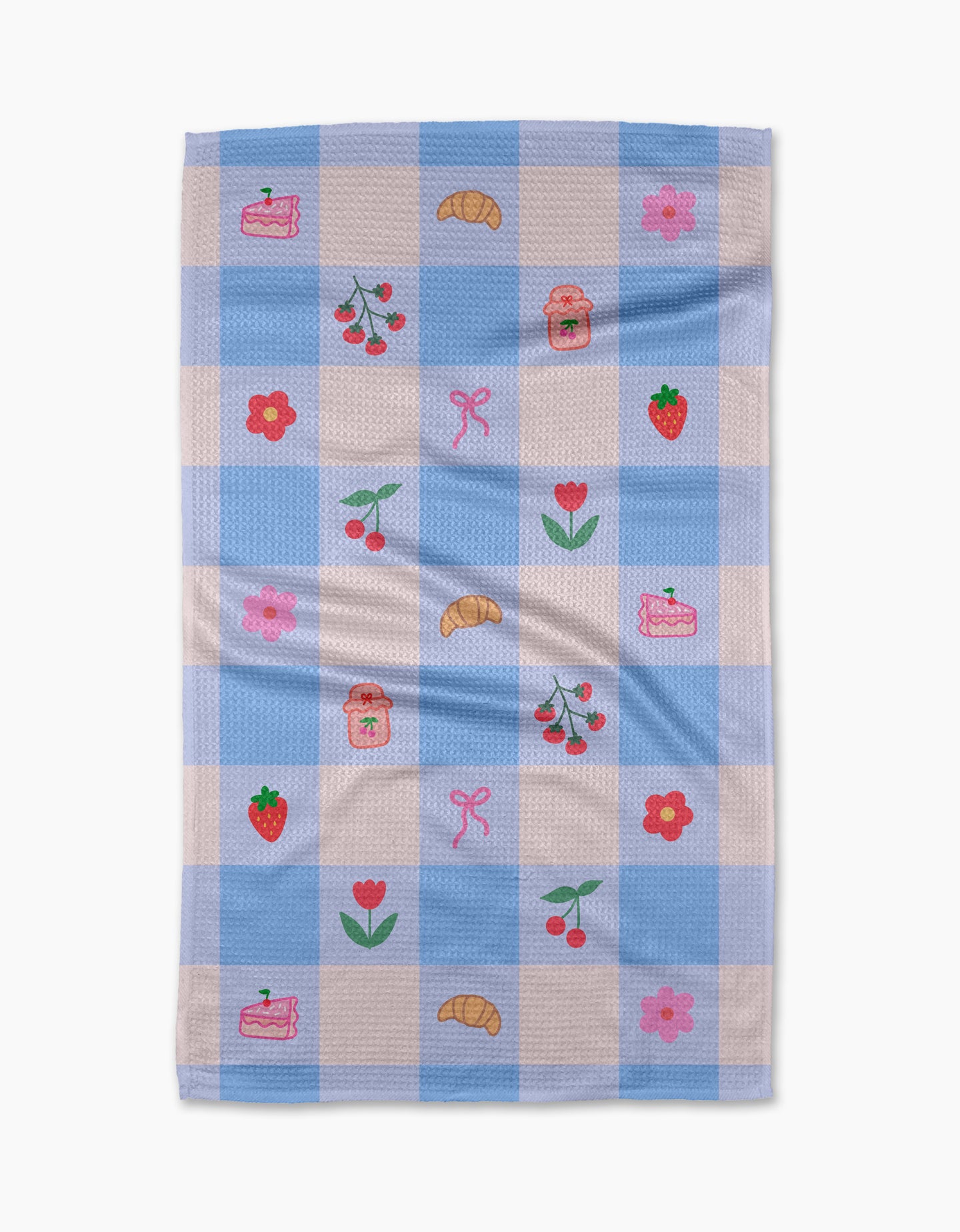 The Little Picnic Things tea towel by Letters By Shells is made from recycled materials and features blue and white checks with embroidered croissants, cherries, strawberries, jam jars, cake slices, pink bows, red tulips, and pink flowers.
