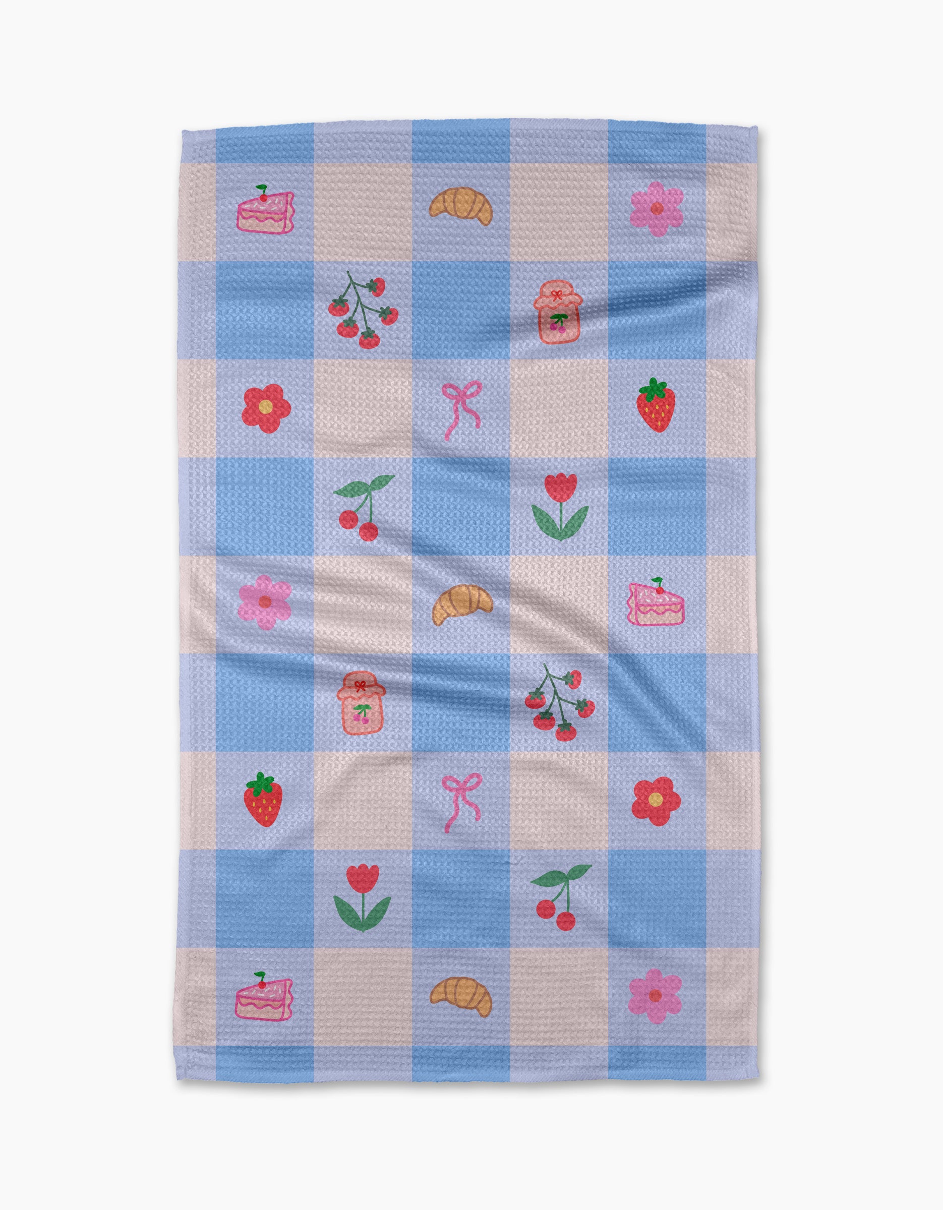 The Little Picnic Things tea towel by Letters By Shells is made from recycled materials and features blue and white checks with embroidered croissants, cherries, strawberries, jam jars, cake slices, pink bows, red tulips, and pink flowers.