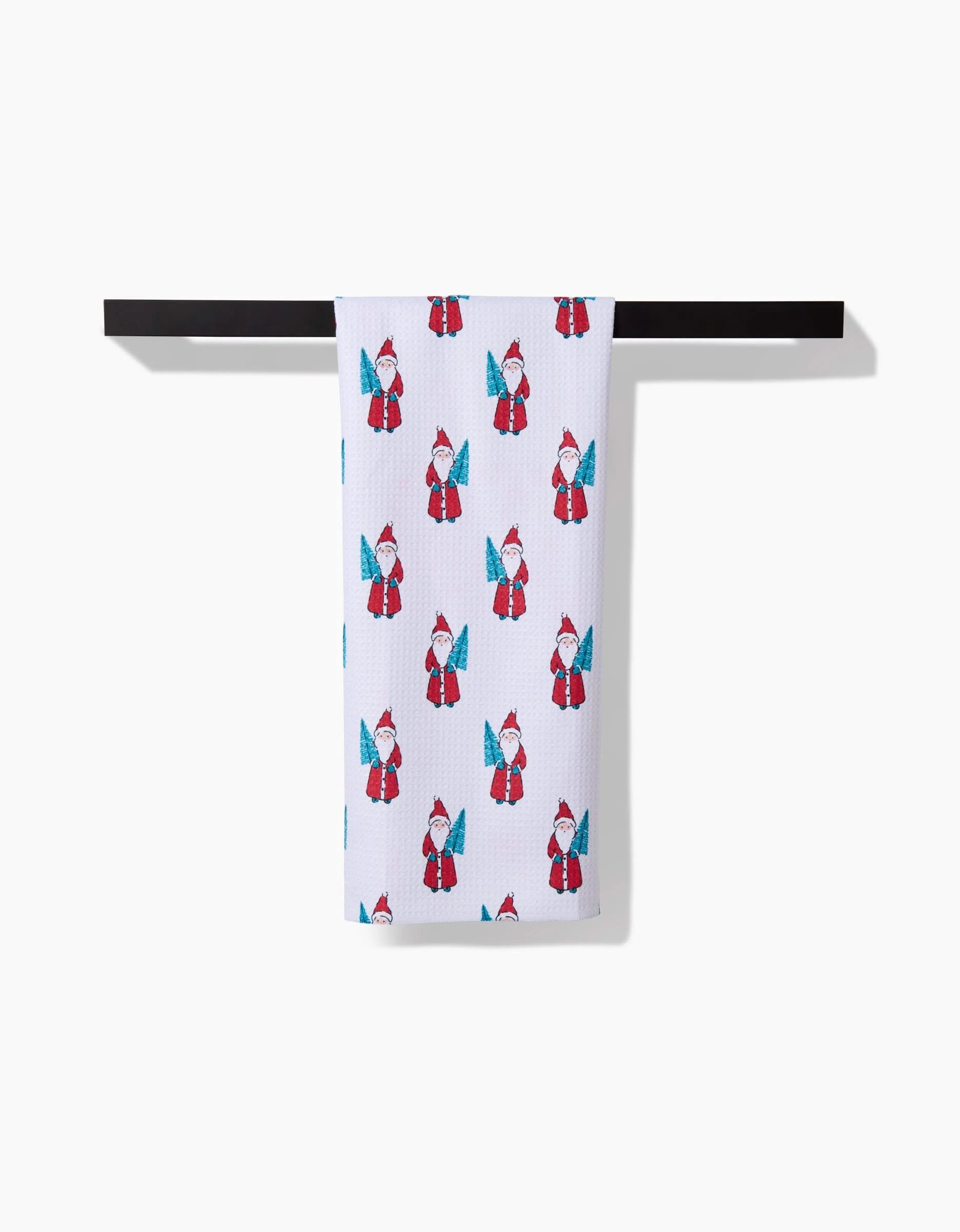 The Hufton Studio Little Santa towel, white with a red and blue garden gnome pattern, hangs neatly on a black towel bar against a plain white background.