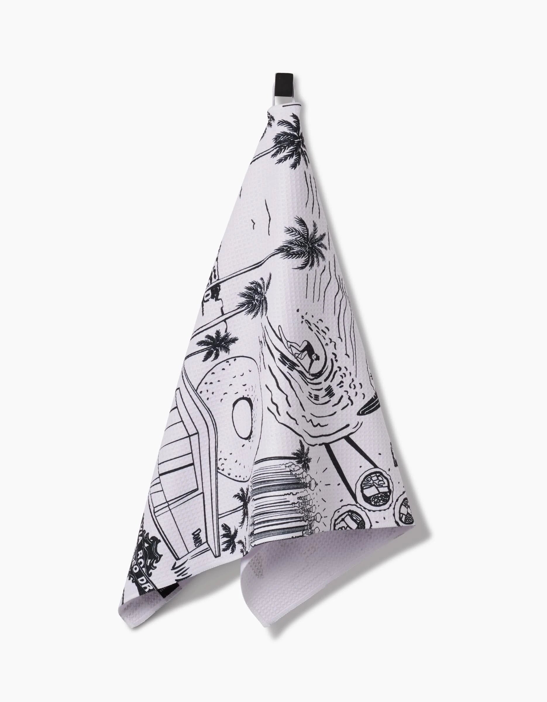 The Los Angeles tea towel by Elisabeth Wing features black line art of palm trees, a swimmer, and pool scenes on white Geoweave™ fabric, finished with a black hanging loop.
