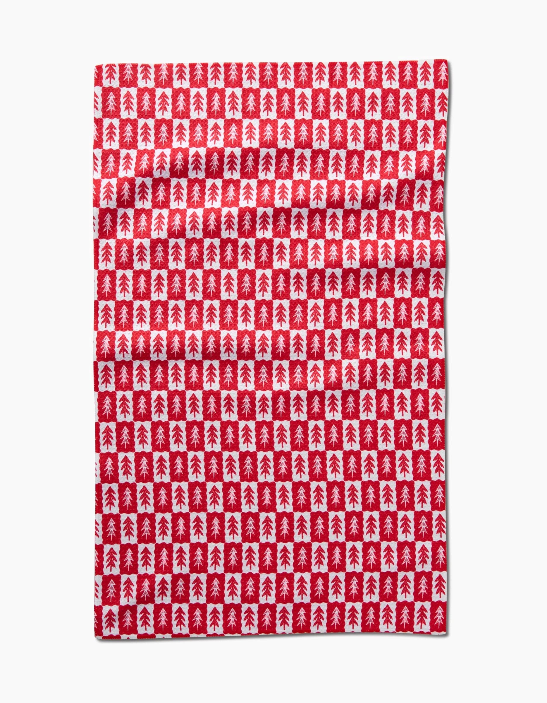 The Louis Pines tea towel by Roxy Marj features a festive red and white checkerboard design with small Christmas trees, offering ultra-absorbency for the holiday season.