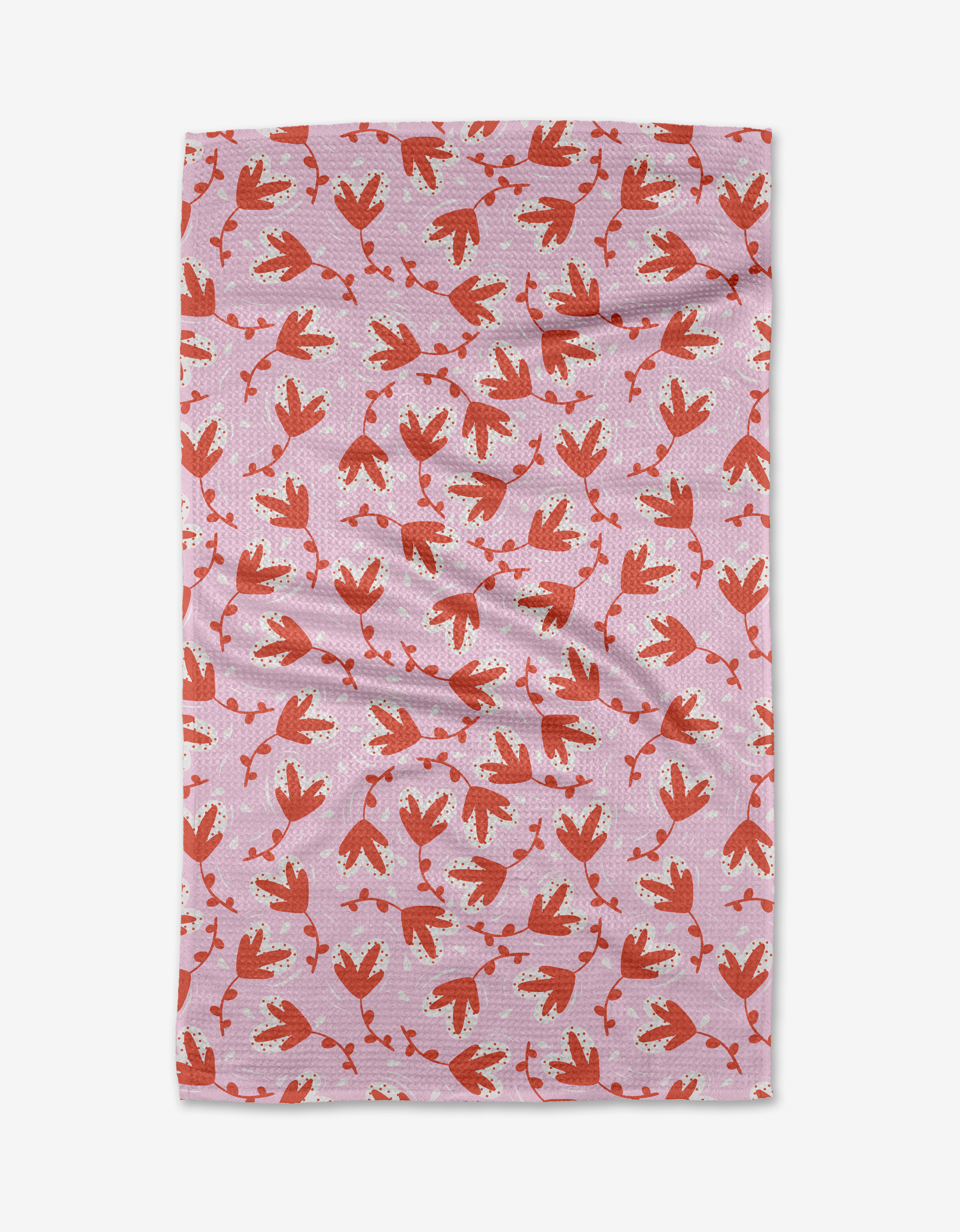 The Love Blooms tea towel by Charlie Rowan Designs is a rectangular pink towel with red and orange bird footprints, white accents, made from recycled materials, and shown flat against a white background.