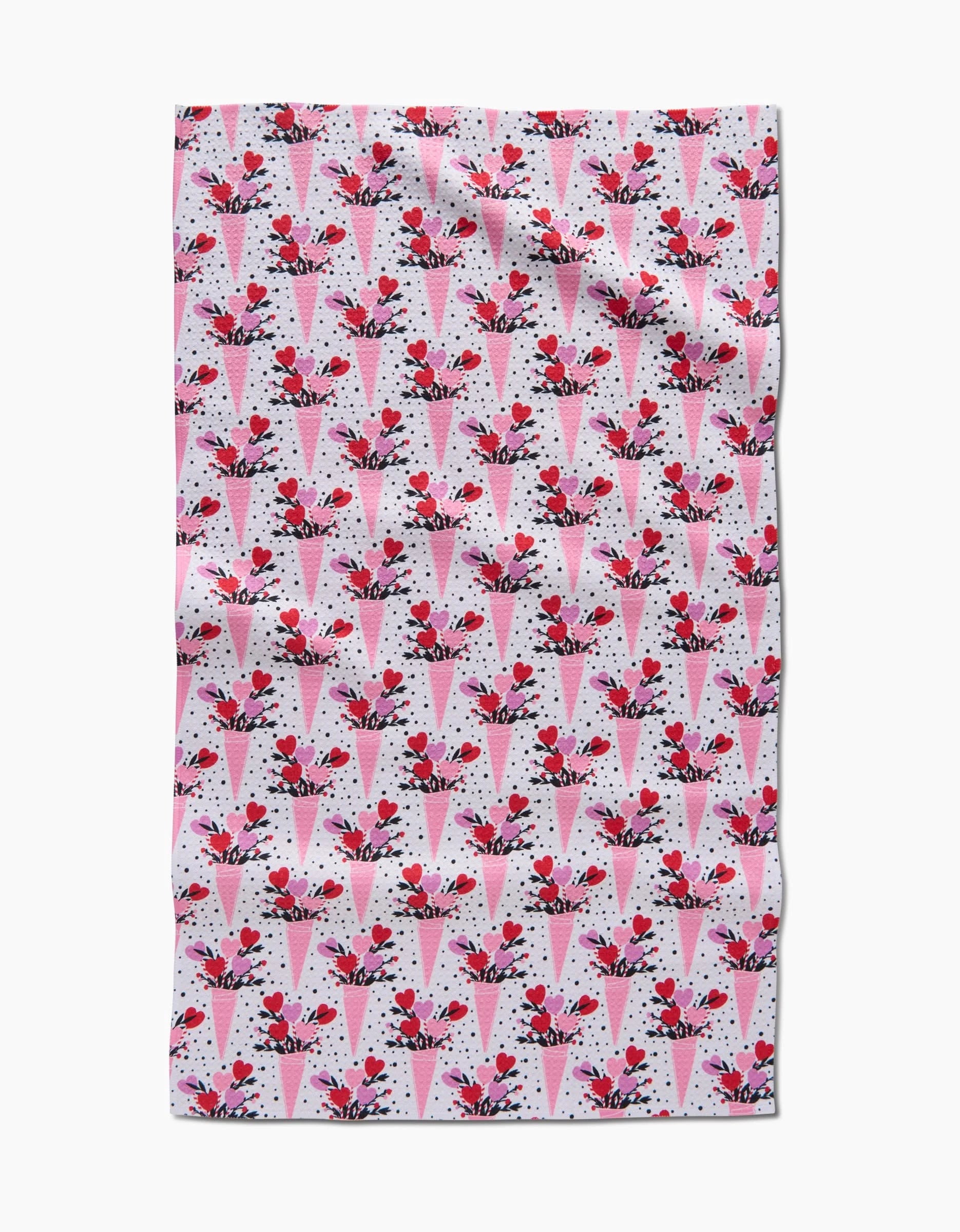 The Love Bouquet recycled kitchen towel by Charlie Rowan Designs features a pattern of pink and red ice cream cones with cherries on a white background with black dots.