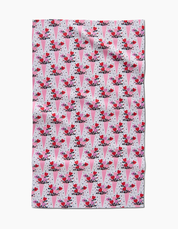 The Love Bouquet recycled kitchen towel by Charlie Rowan Designs features a pattern of pink and red ice cream cones with cherries on a white background with black dots.